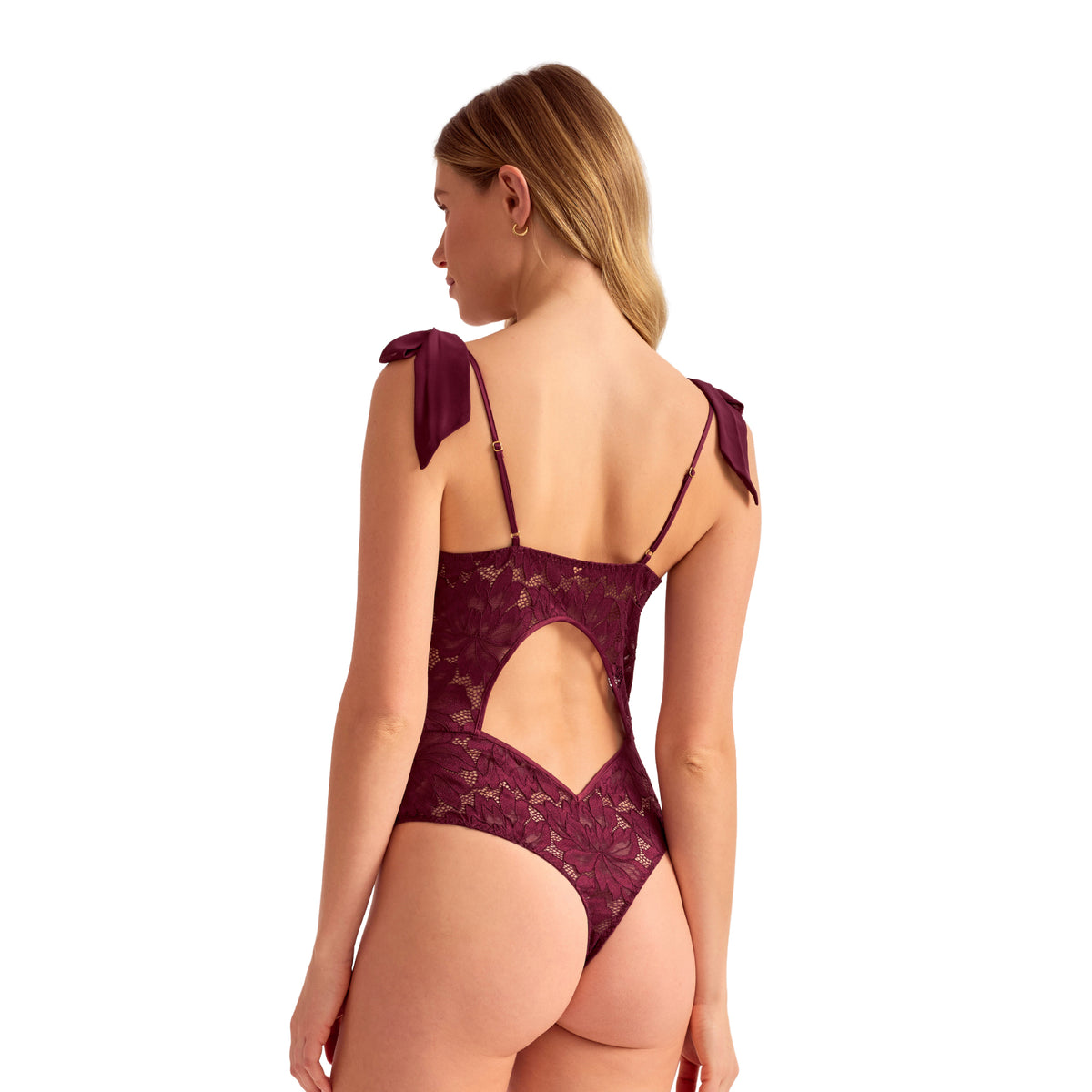 Dark cherry floral lace bodysuit featuring adjustable straps, shoulder bows, an open-back cutout and cheeky bottom, back view.