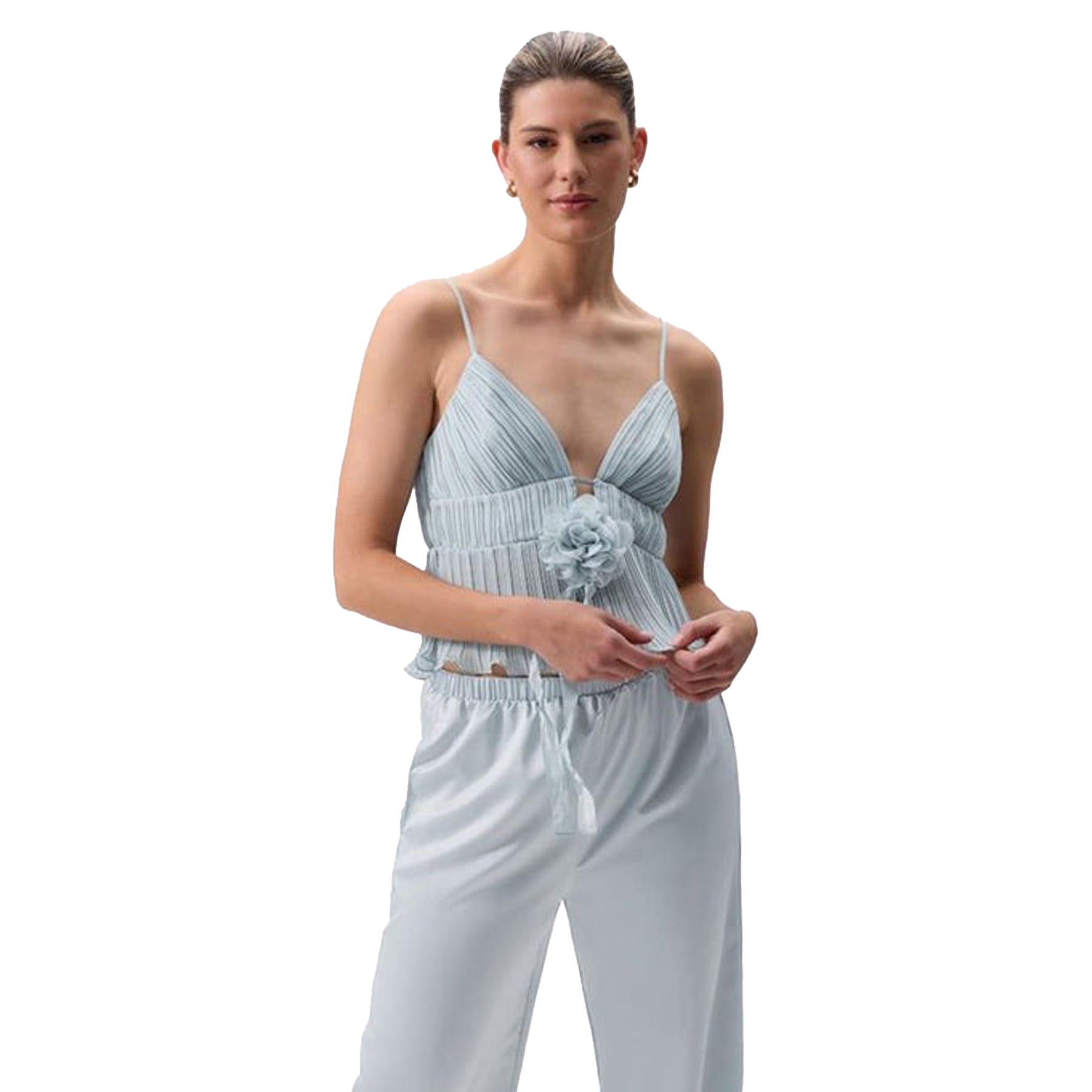 Close-up of light blue pleated camisole with floral accent, styled with matching satin pants.