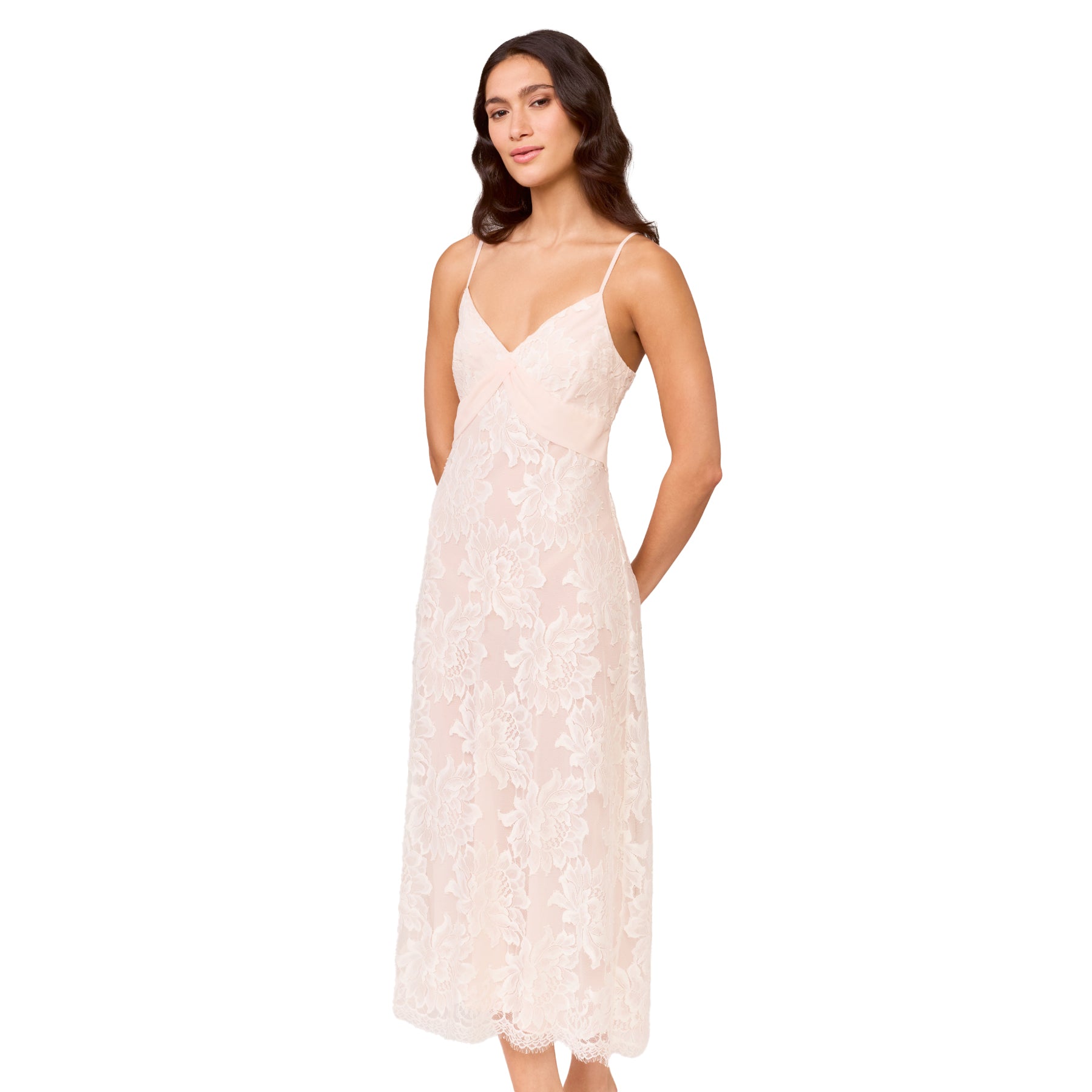 Blush lace bridal gown with delicate floral lace, V-neckline, and slim adjustable straps, shown on model against a white background.