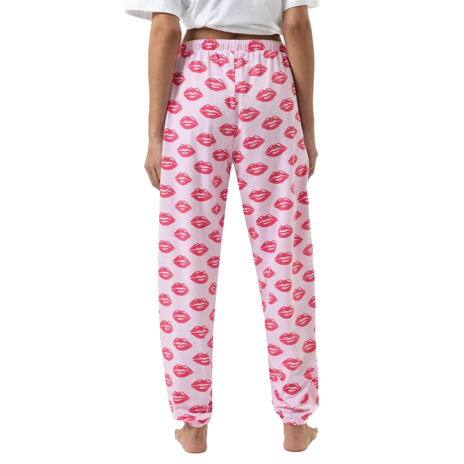 Back view of pink jogger pants with red lips print and elastic cuffs.