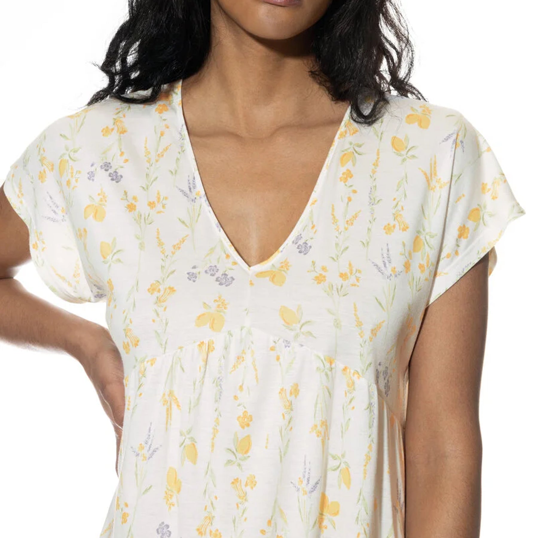 Close-up of the nightdress neckline and bust area, highlighting the gathered detailing under the bust and soft floral print.