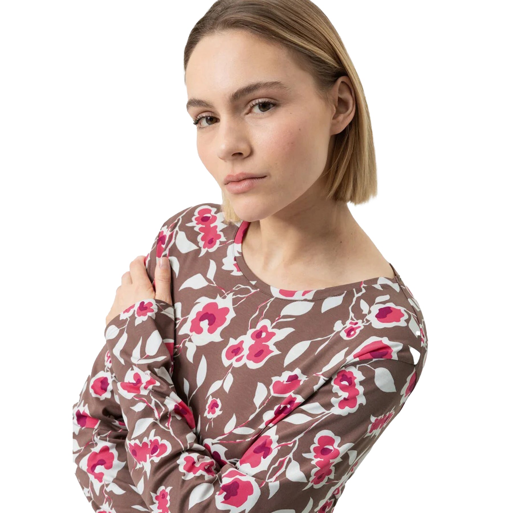 Close-up of woman in taupe floral nightgown with pink and white flower design.