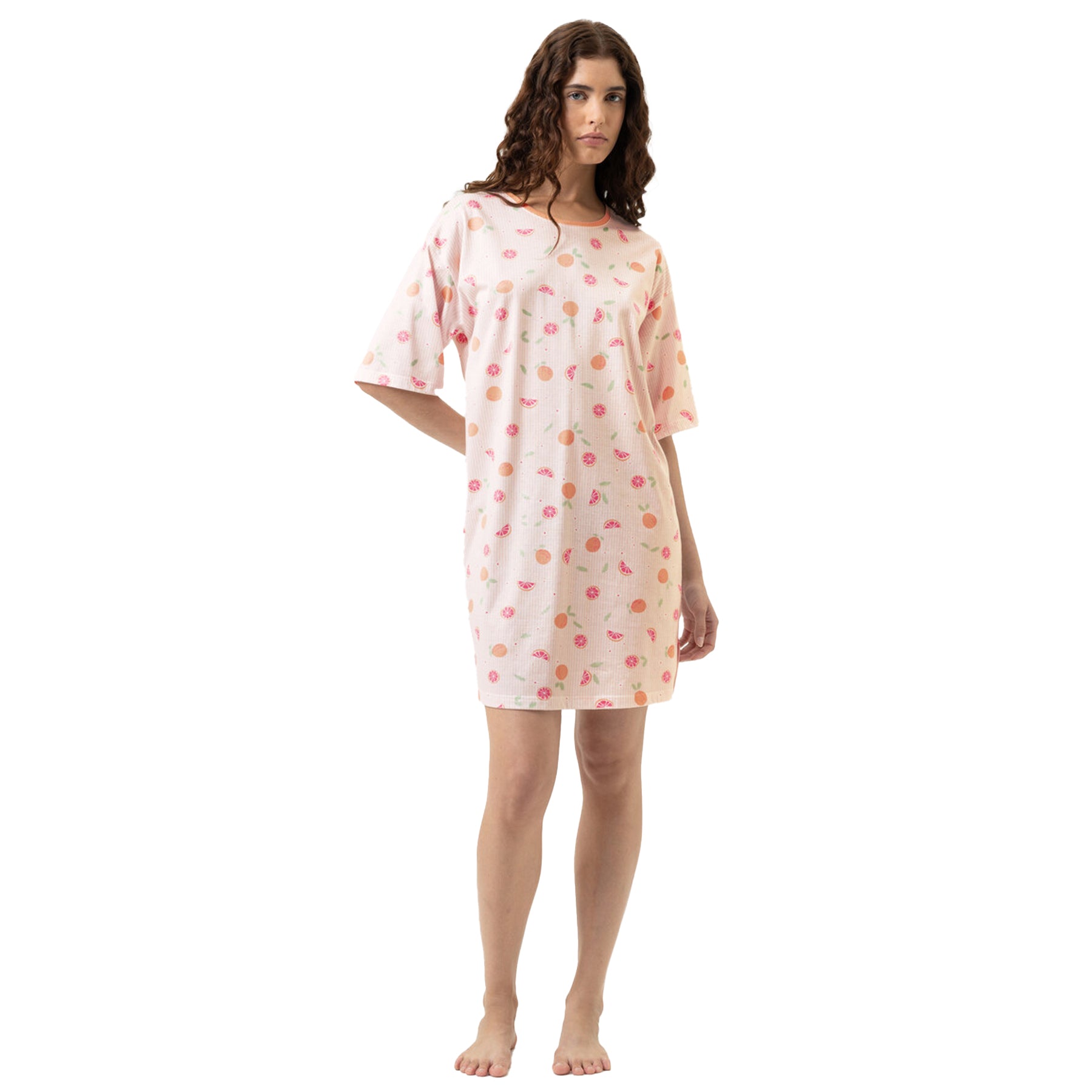 Woman wearing citrus print short sleeve sleep dress with peach and grapefruit pattern