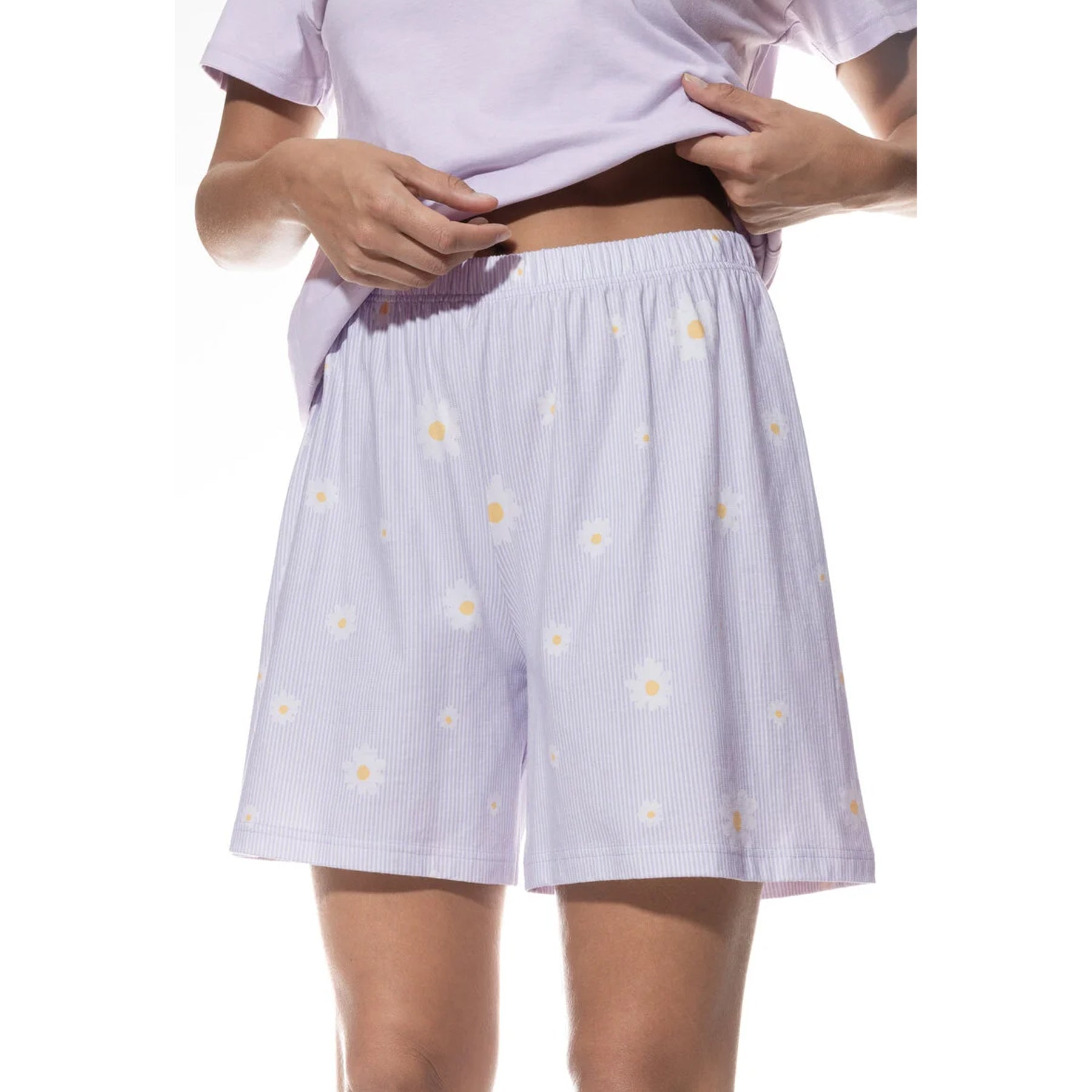 Close-up of lavender pajama shorts with white daisy print and elastic waistband.