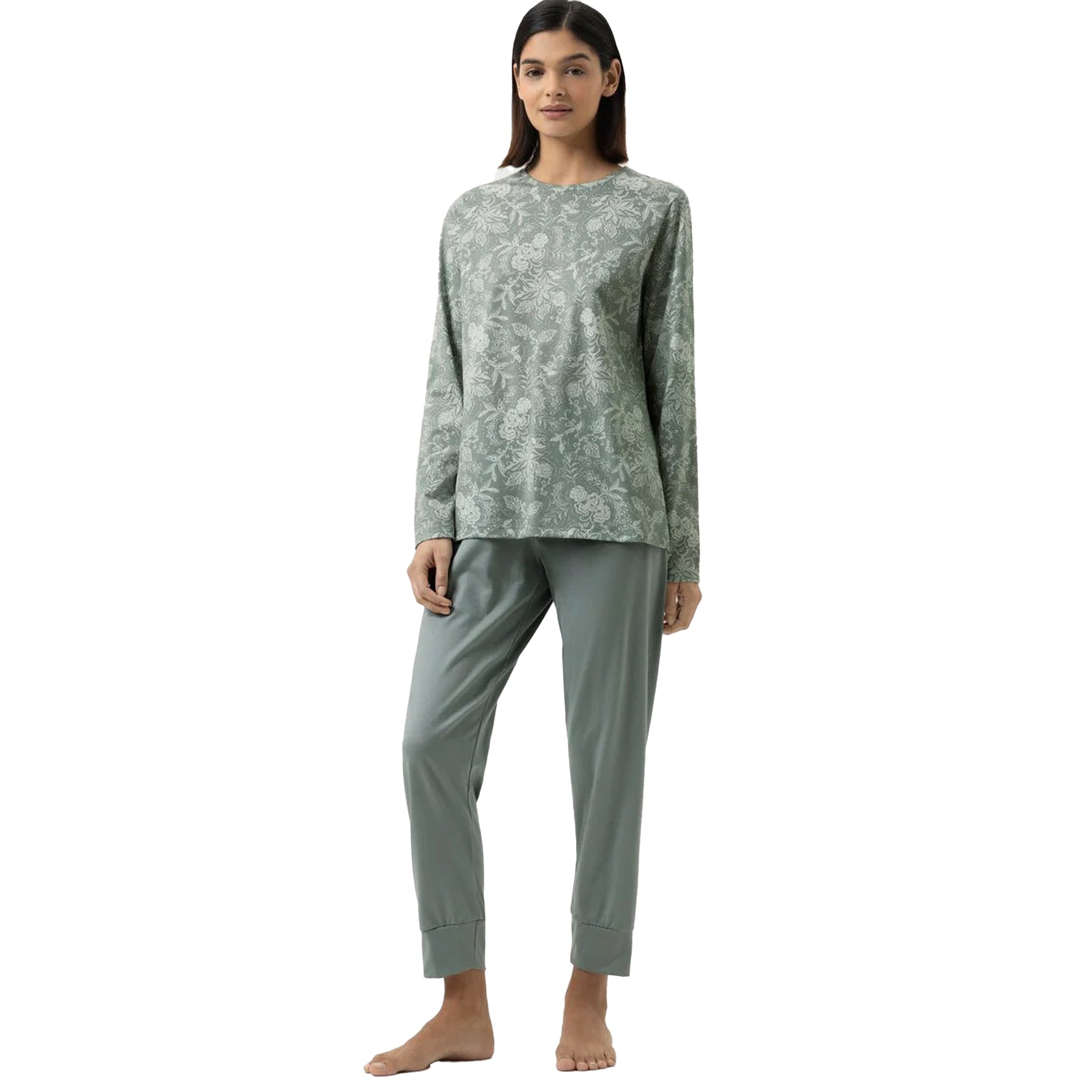 Model wearing sage green pyjama set with floral long-sleeve top and solid cuffed pants.