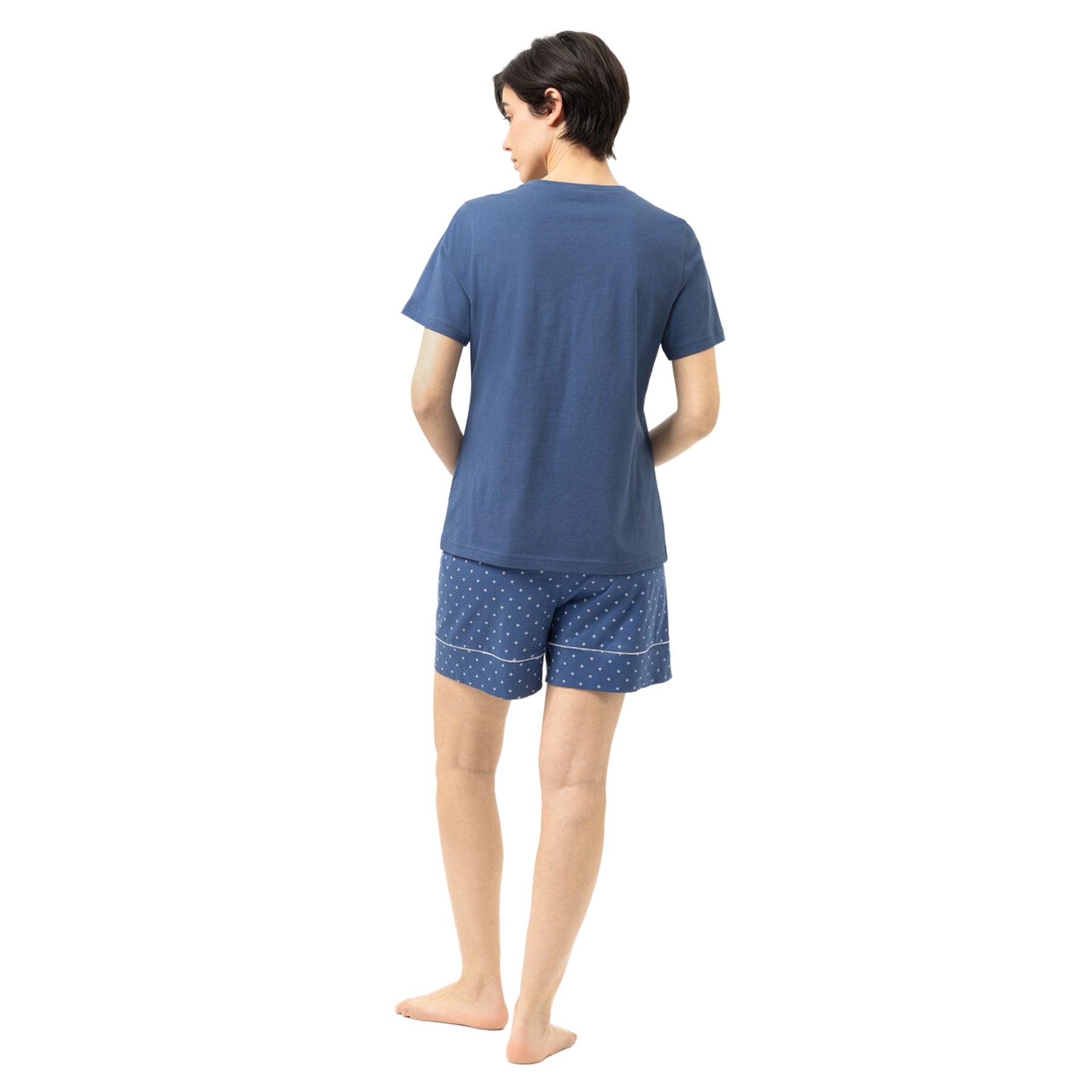 Back view of the Mey Midnight Dust pajama set featuring a solid blue T-shirt and matching blue geometric print shorts.