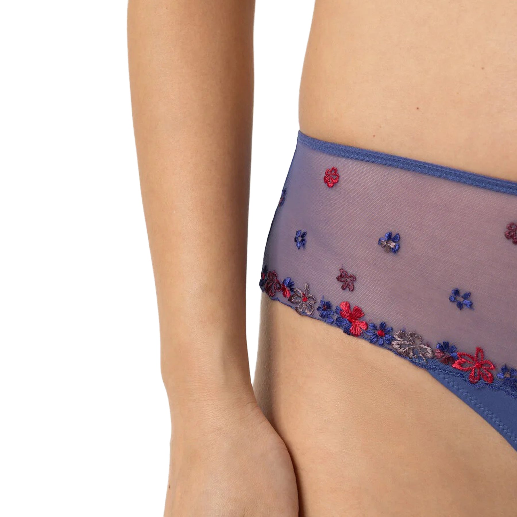 Close-up of sheer mesh waistband with multicolour floral embroidery on blue bikini briefs