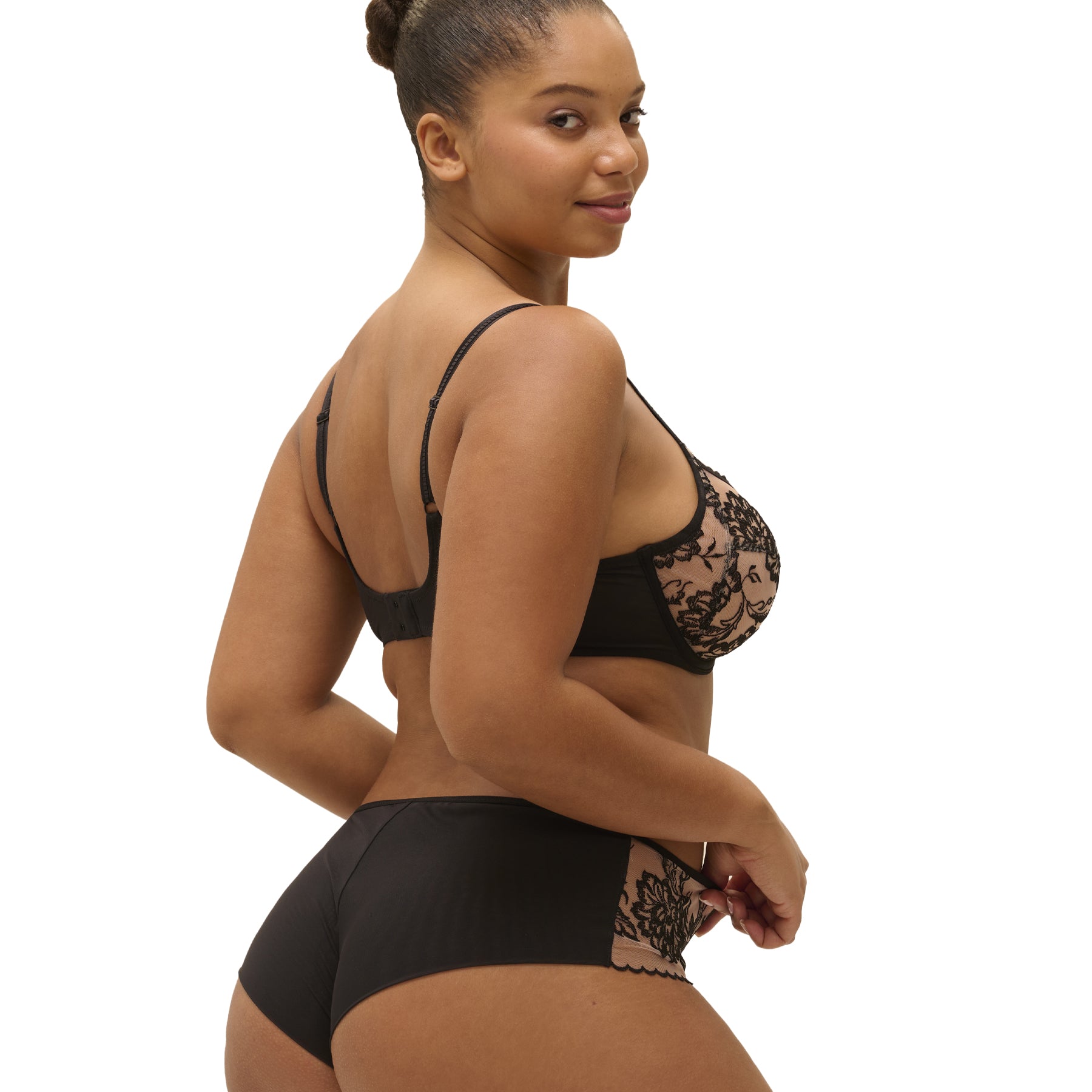 Side and back view of black embroidered full cup bra with sheer mesh, worn by model.