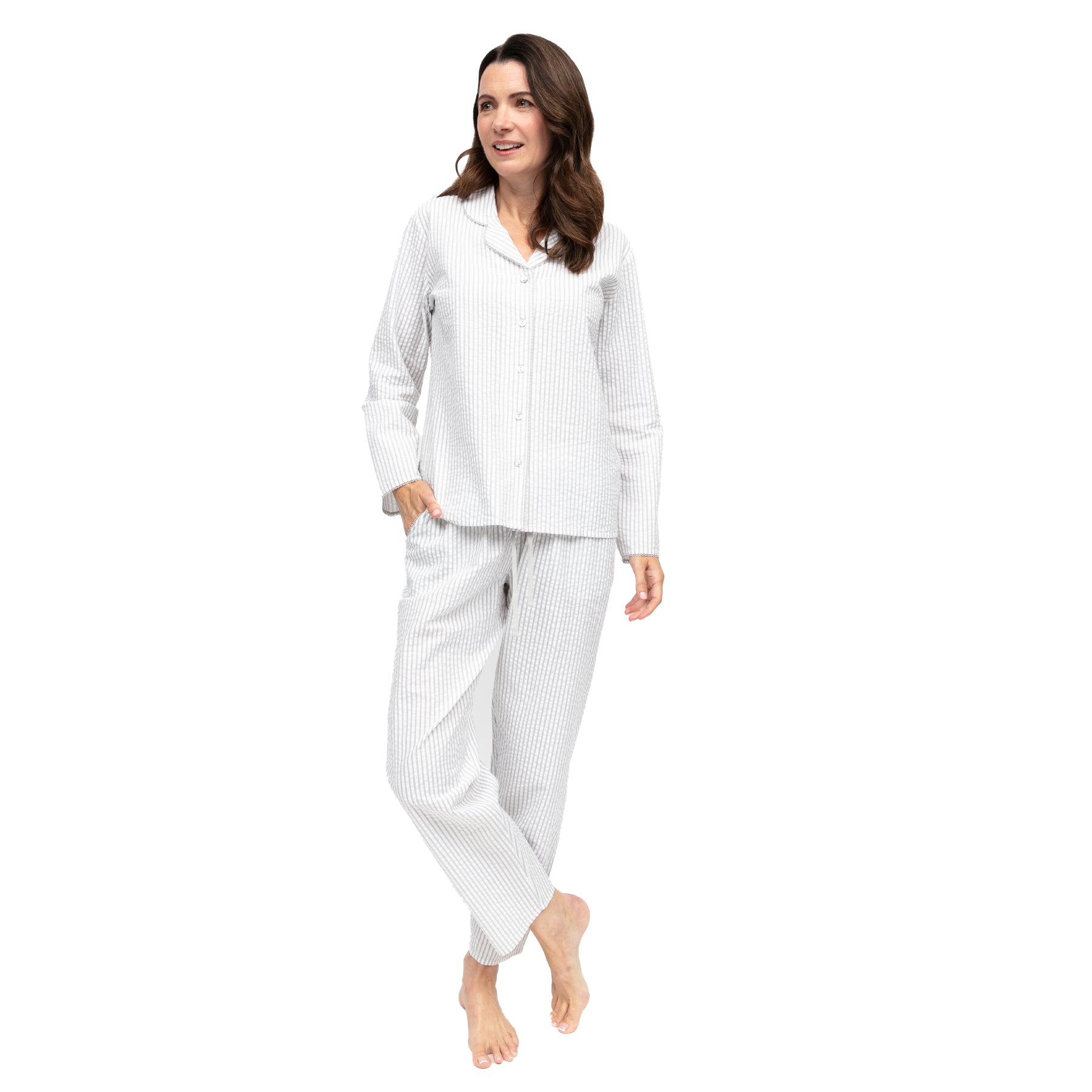 Front view of women’s light grey and white striped pyjama set with button-front long-sleeve top and straight-leg pants on white background.