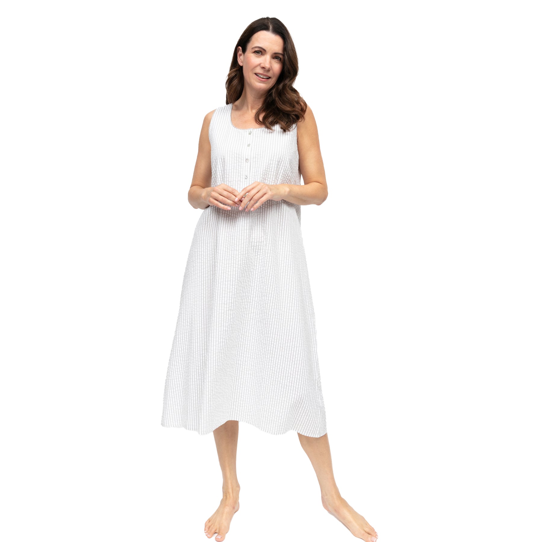 Woman wearing light grey vertical stripe sleeveless nightdress with button placket and relaxed A-line silhouette