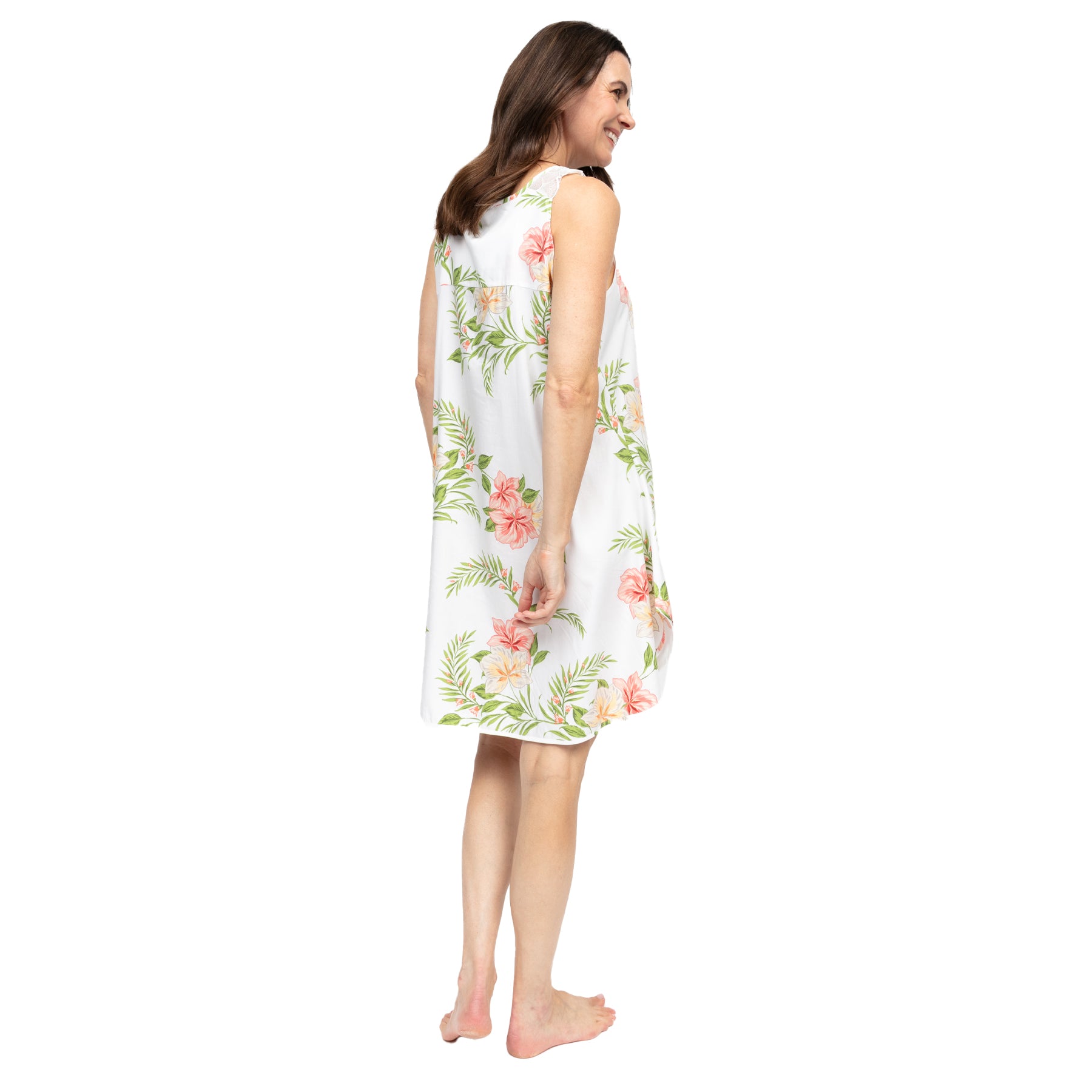Women’s white floral cotton chemise, back view, featuring soft pink hibiscus and green leaf print with a relaxed, airy silhouette