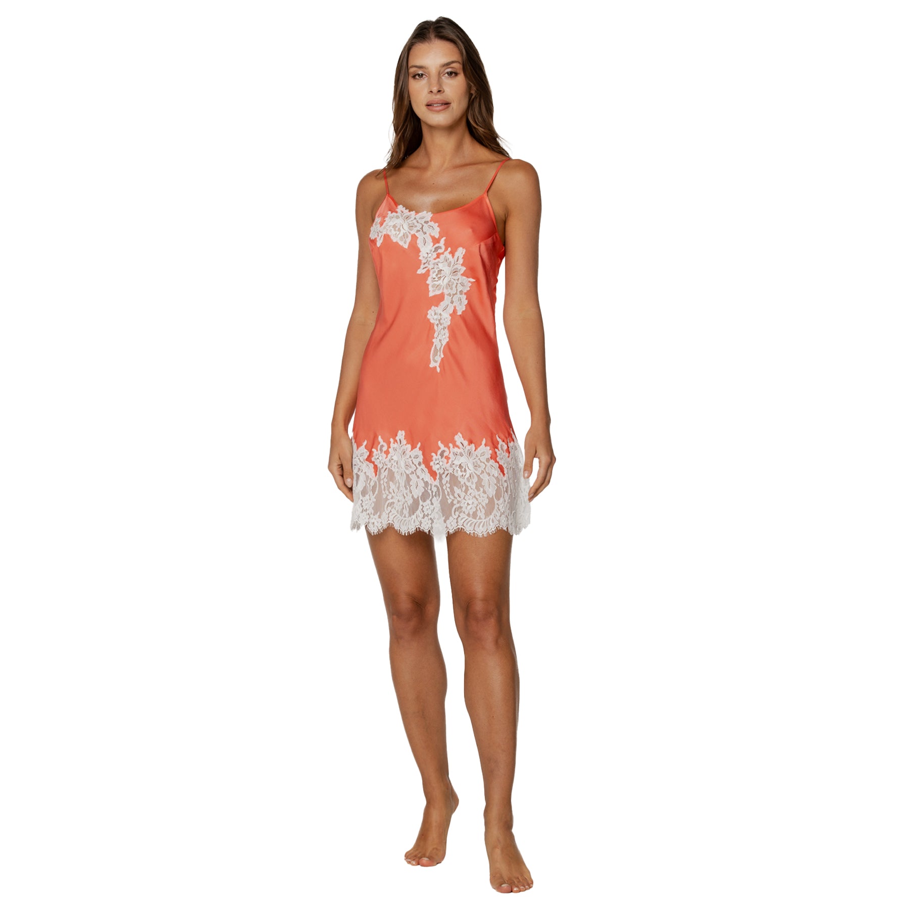 Coral satin chemise with white lace trim and spaghetti straps, front view on model