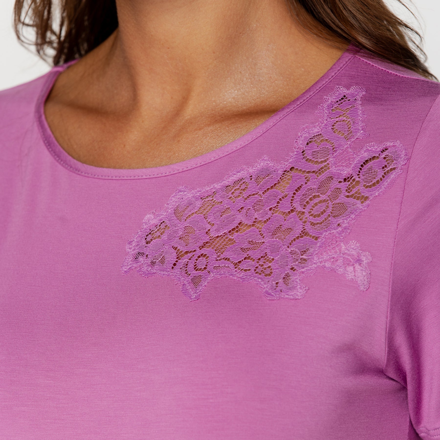 Close-up of pink nightgown neckline with delicate lace appliqué detail