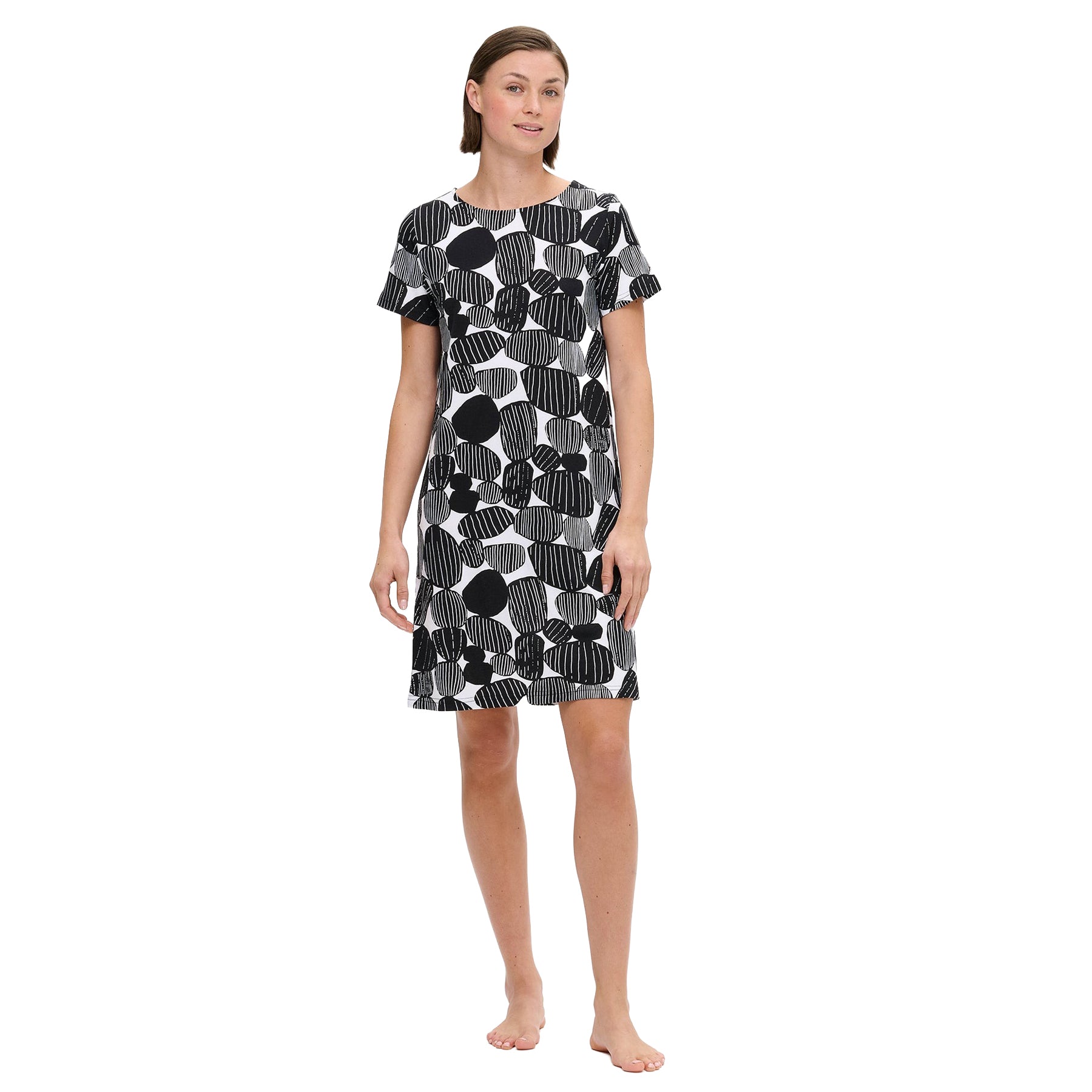 Black and white short-sleeve nightdress with abstract stone print, knee-length silhouette, shown on model standing barefoot against a white background.