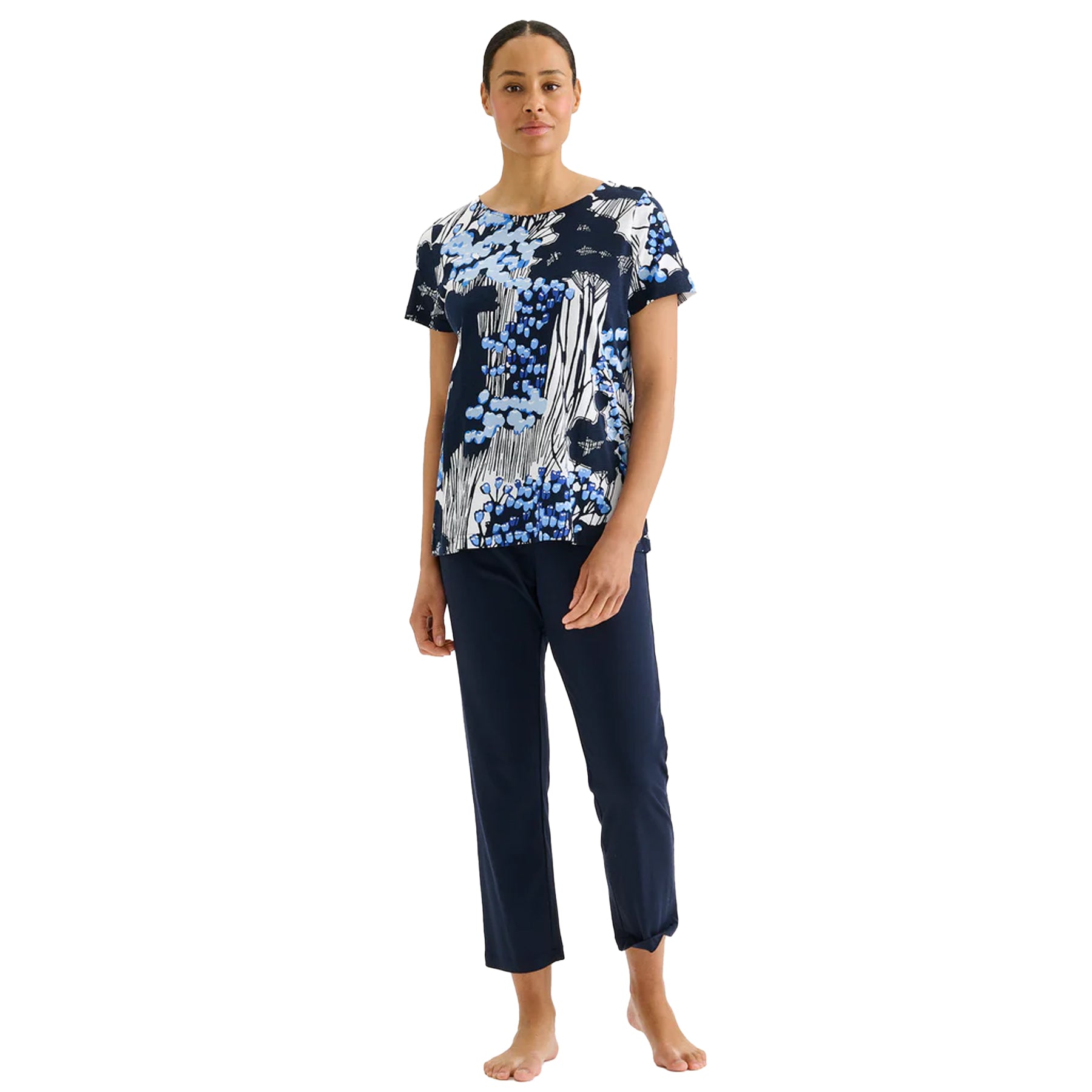 Navy floral print short sleeve pyjama set with blue and white abstract botanical top and solid navy pants, relaxed fit sleepwear on model