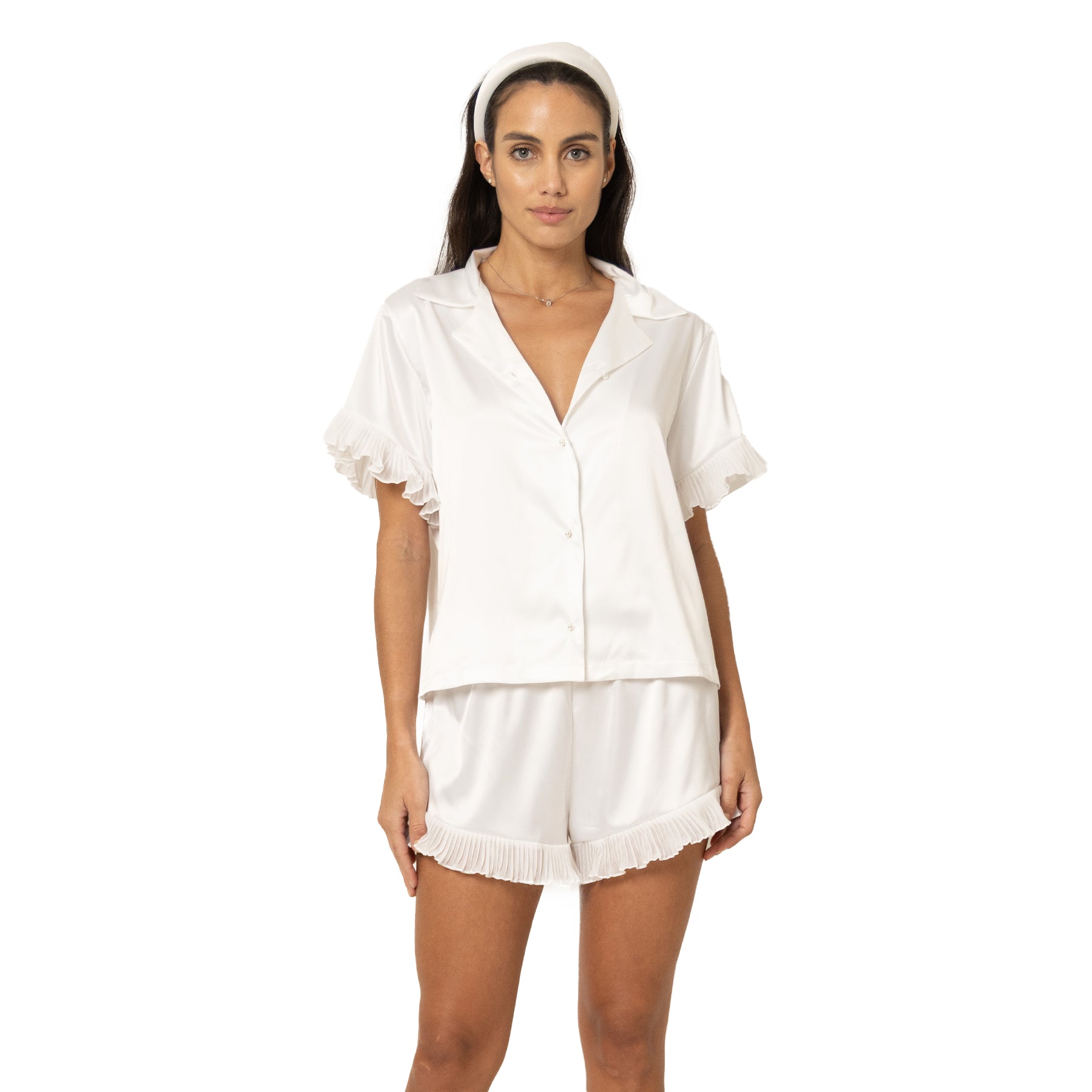 Front view of off-white satin pyjama set with button-up top and soft ruffle hem shorts