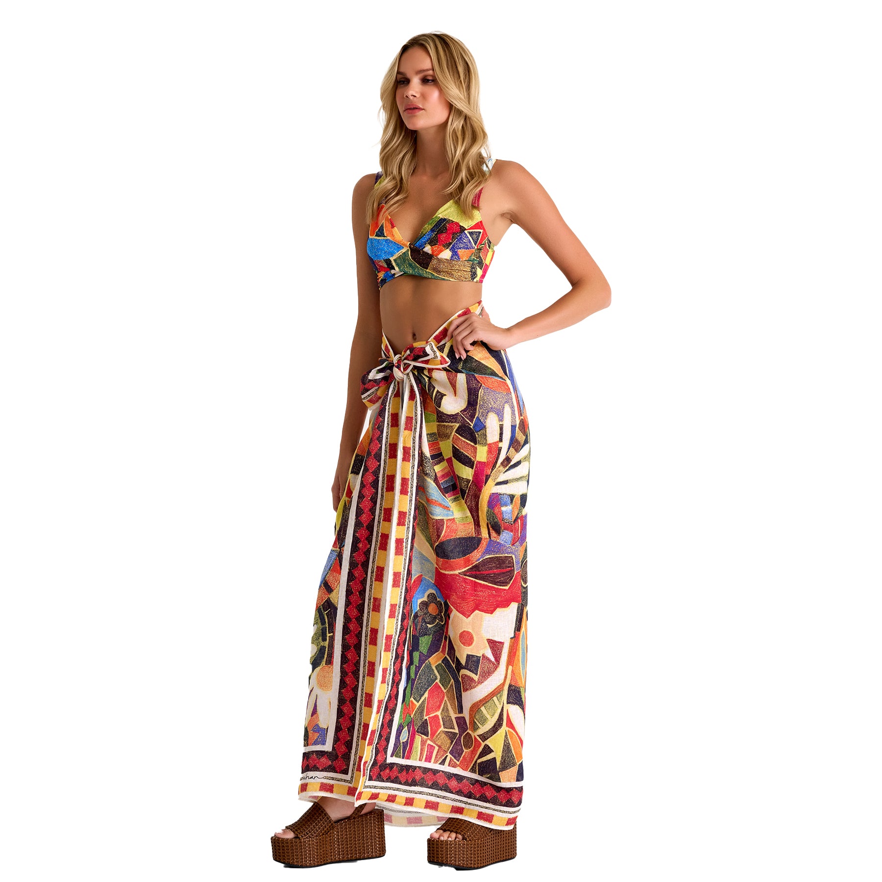 Woman wearing a colorful bikini and matching skirt on a white background