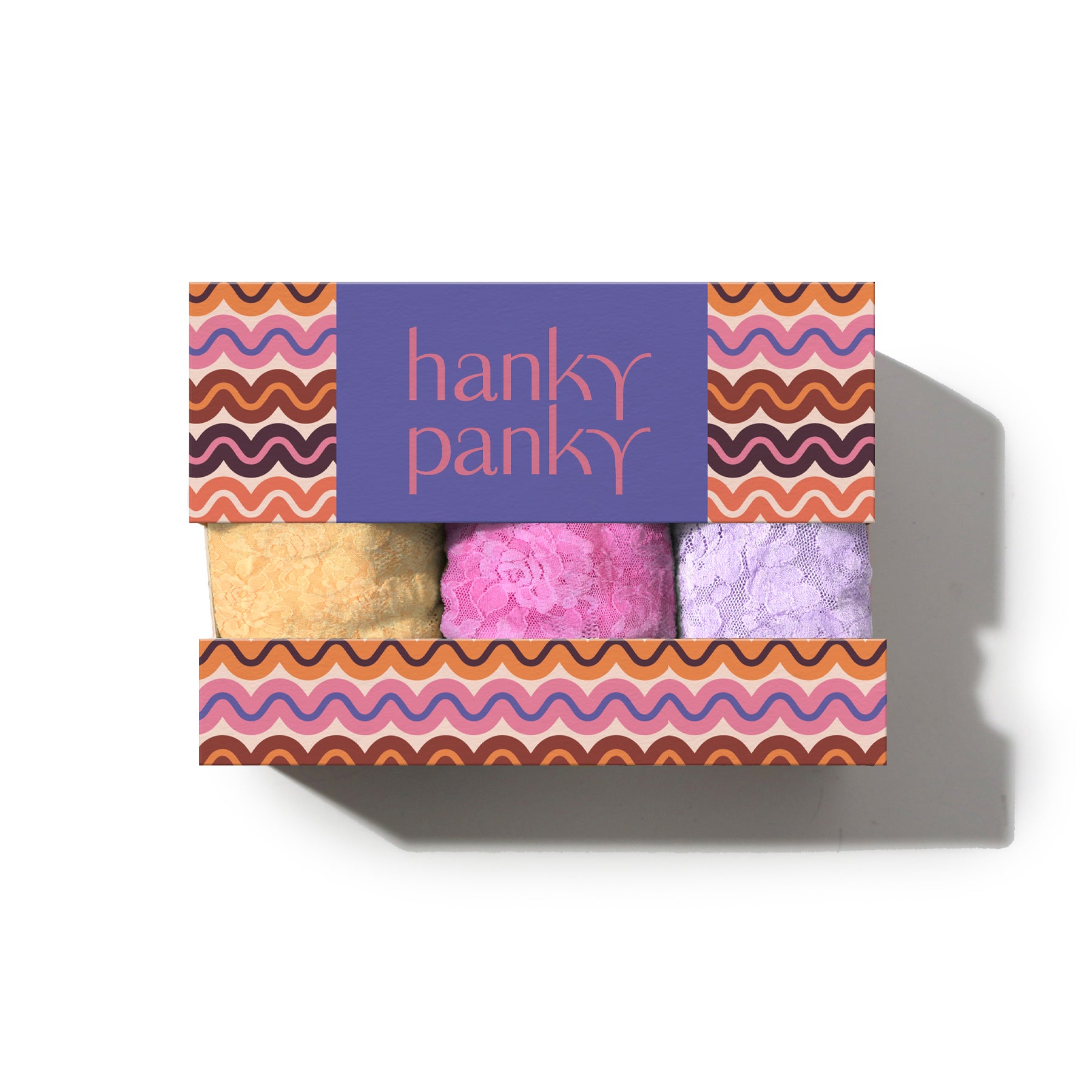Hanky Panky gift box featuring three signature lace thongs in yellow, pink, and lavender.