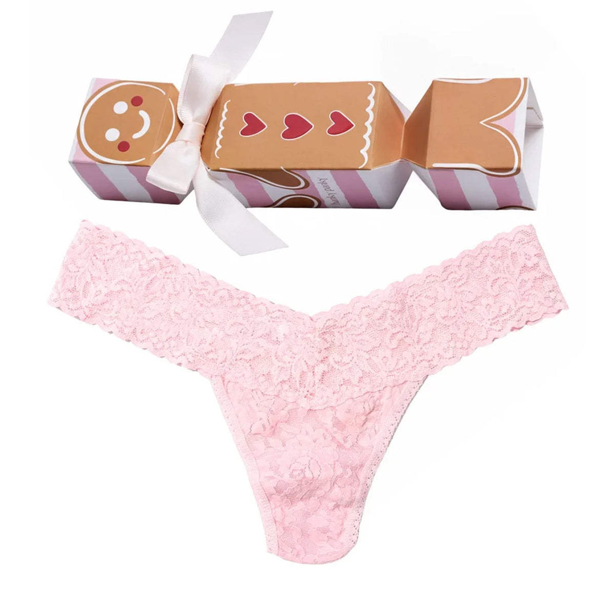 Hanky Panky Signature Lace Low Rise Thong in Bliss Pink, featuring delicate floral lace, a wide scalloped waistband, and a festive gingerbread-themed holiday cracker gift box.