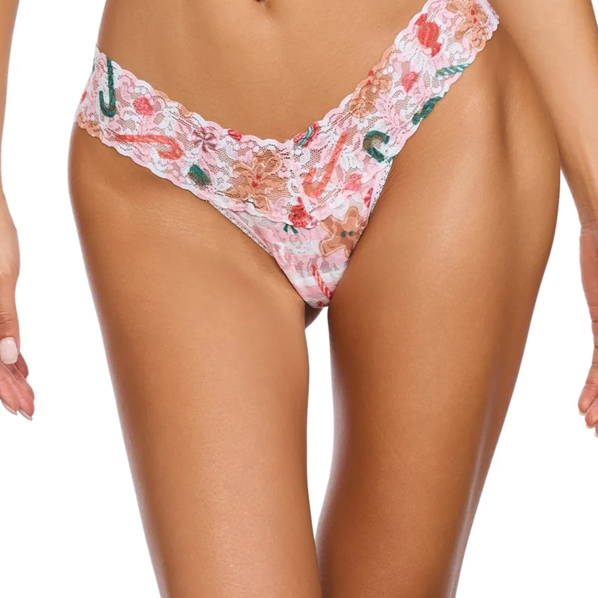 Close-up front view of the Hanky Panky Signature Lace Low Rise Thong in Sugar and Spice, featuring a pink and white holiday print with candy canes, gingerbread cookies, and a wide scalloped lace waistband.