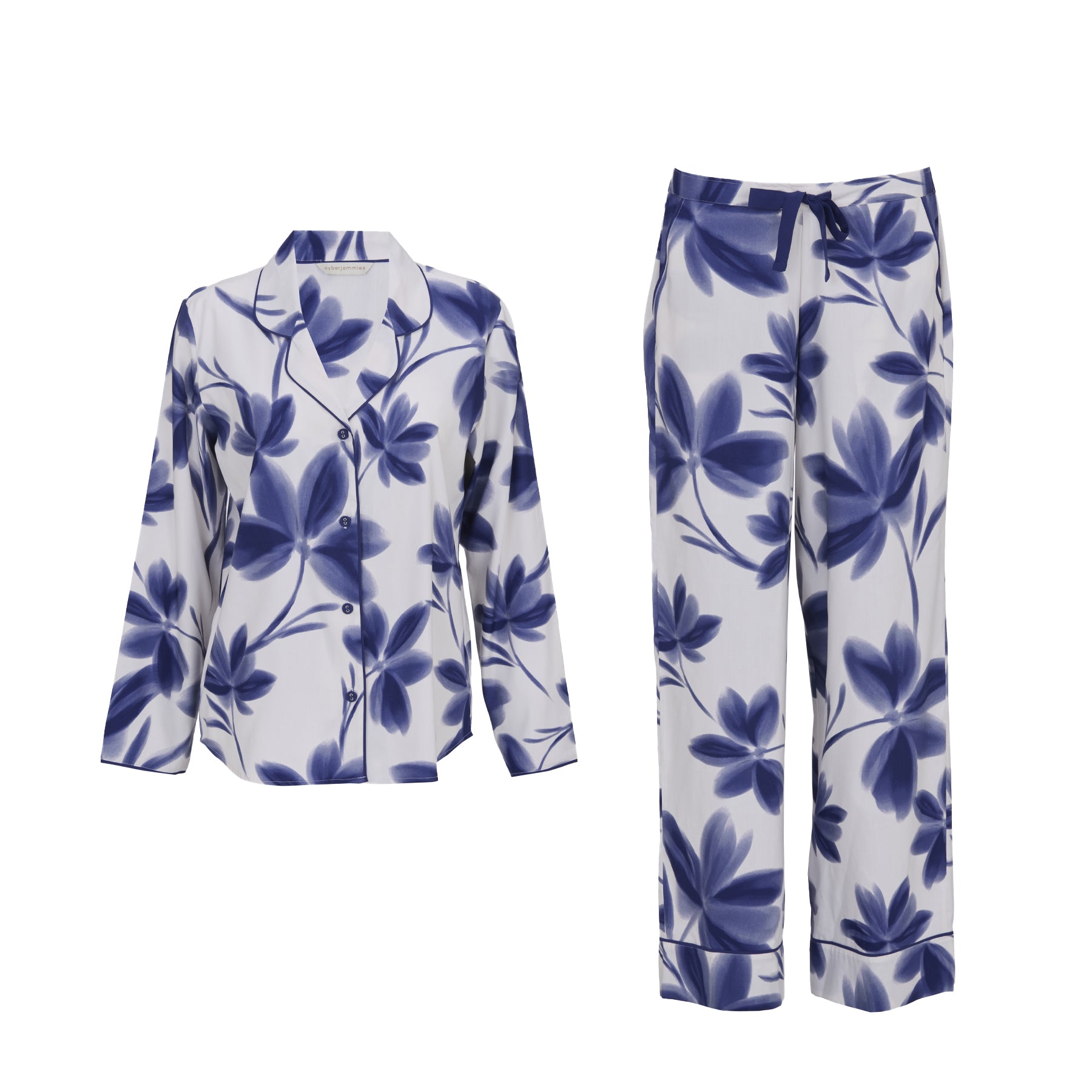 Women’s long sleeve pyjama set in white with oversized navy blue floral print, button-down top with collar and matching wide leg pants.