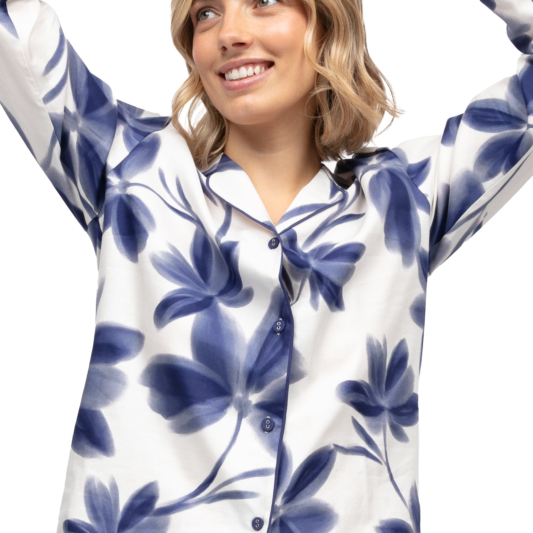 Front view of navy blue floral pyjama set with long sleeves, contrast piping trim and wide leg trousers.