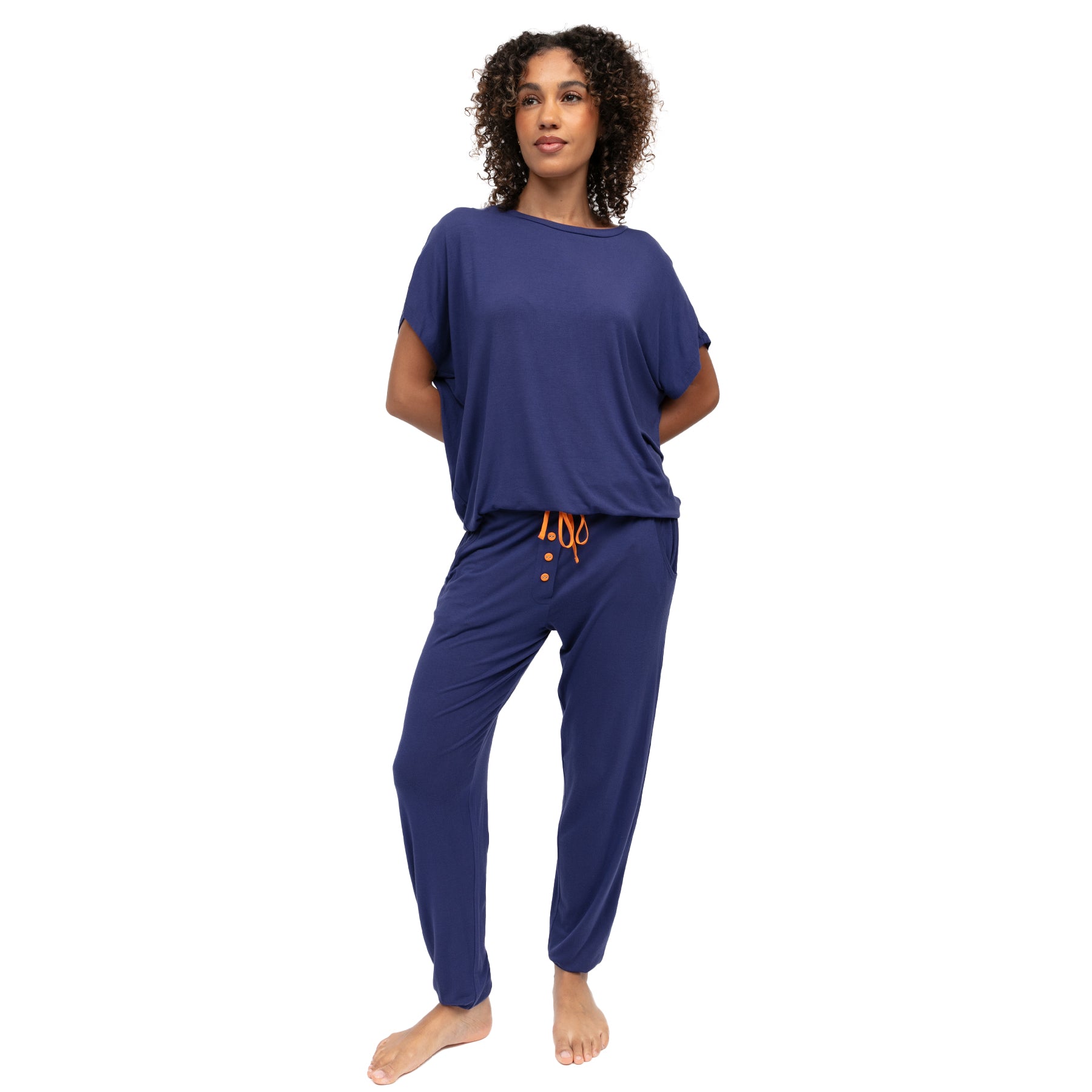 Model wearing navy blue loungewear set with loose fit top and tapered pants with contrast drawstring detail.