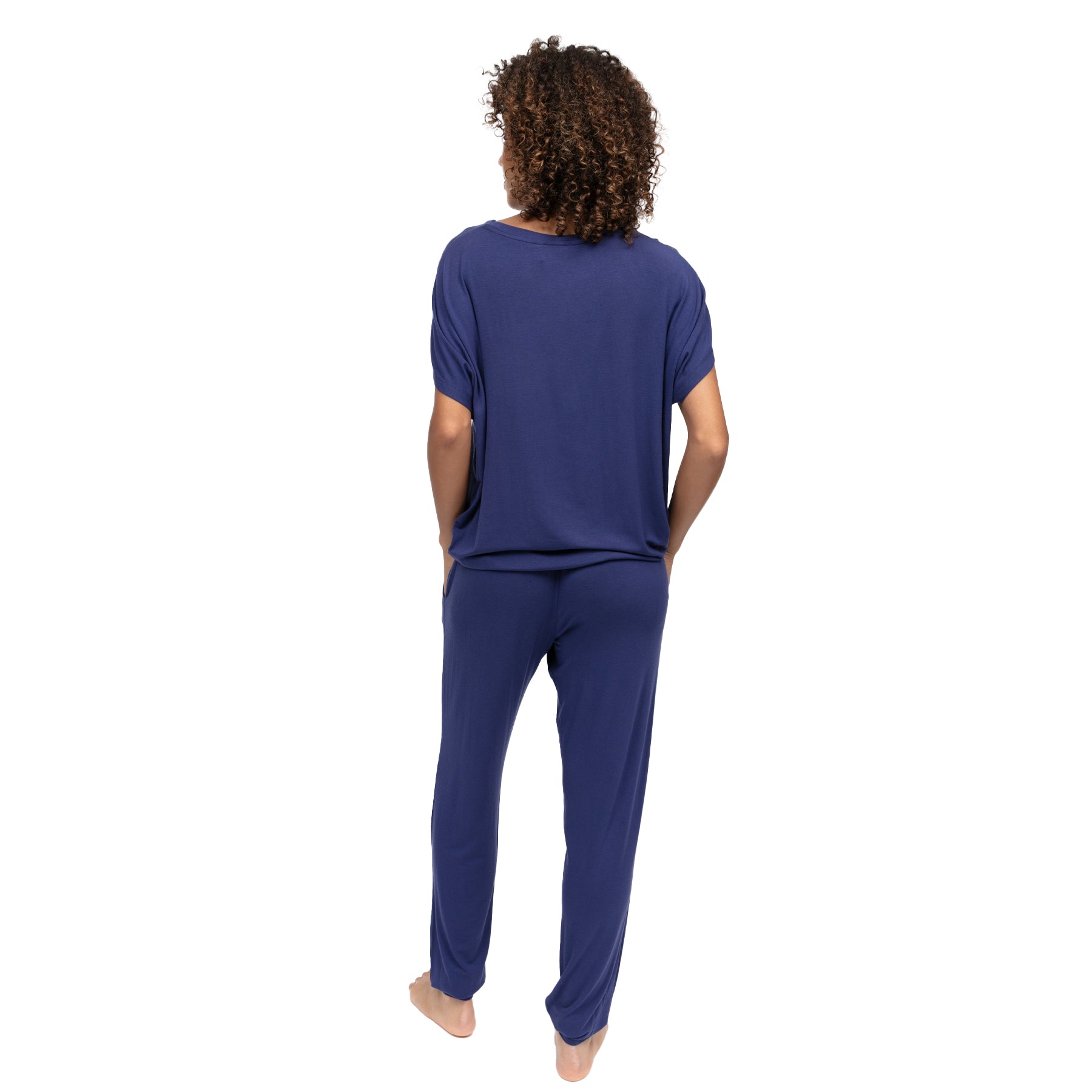 Back view of navy blue two-piece lounge set with soft draped top and comfortable full-length pants.