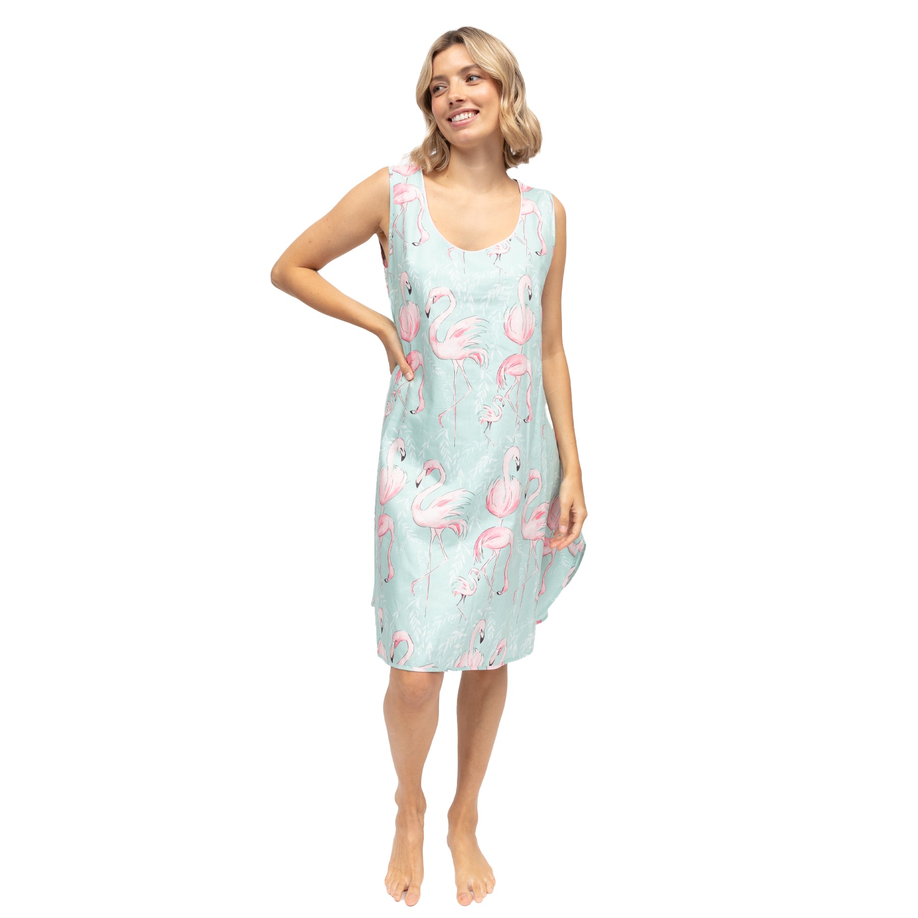 Woman wearing mint flamingo print chemise with sleeveless design and soft drape fit, knee-length nightdress