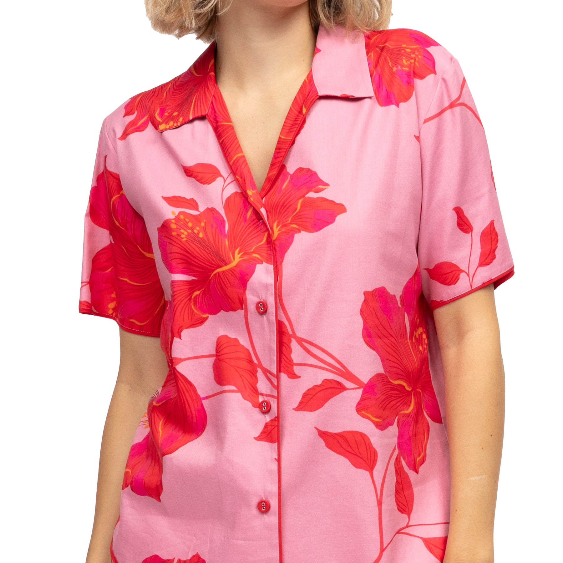 Close-up of pink pajama shirt with red floral print, button front and soft collar detail