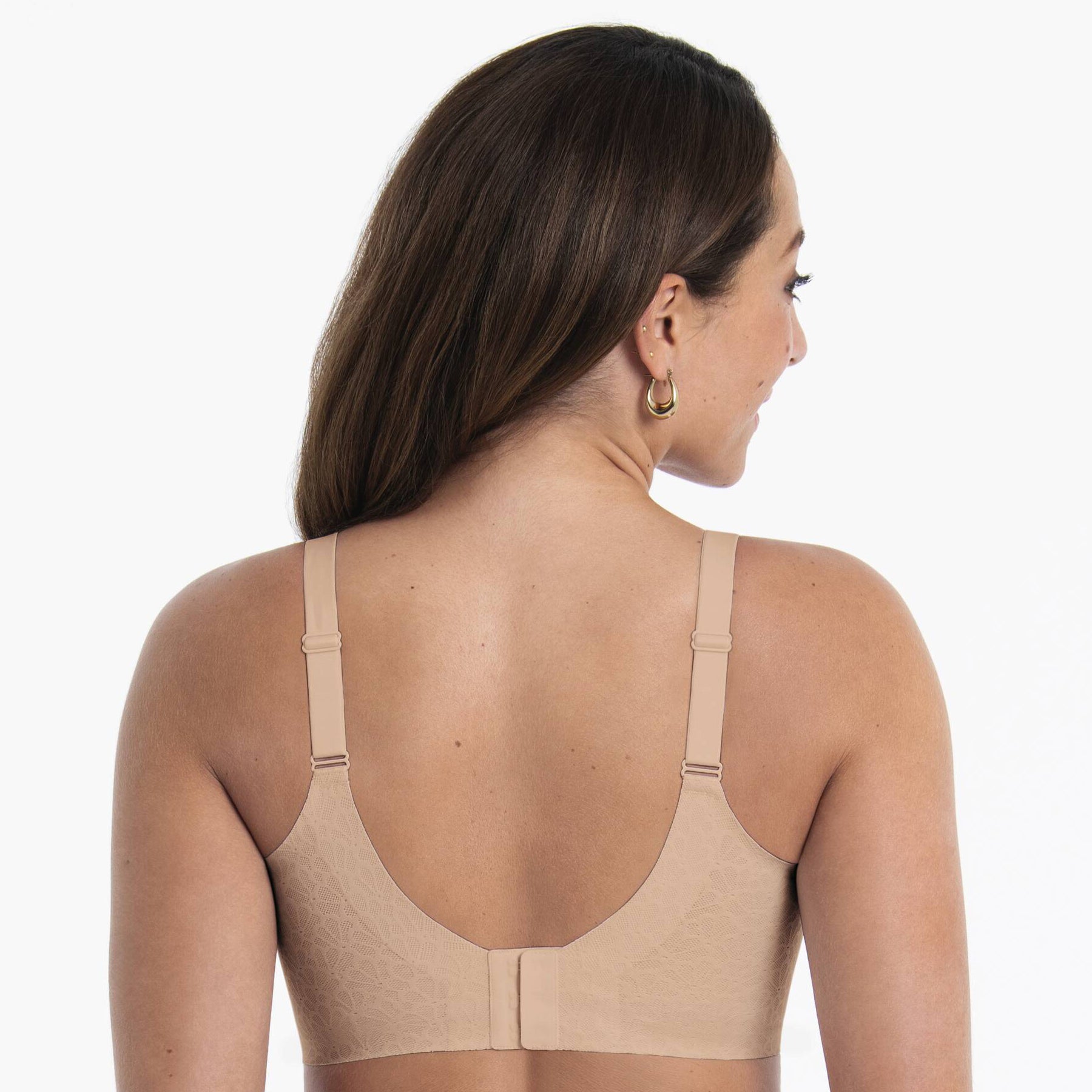 Back view of beige wireless bra with adjustable straps and hook-and-eye closure for everyday comfort