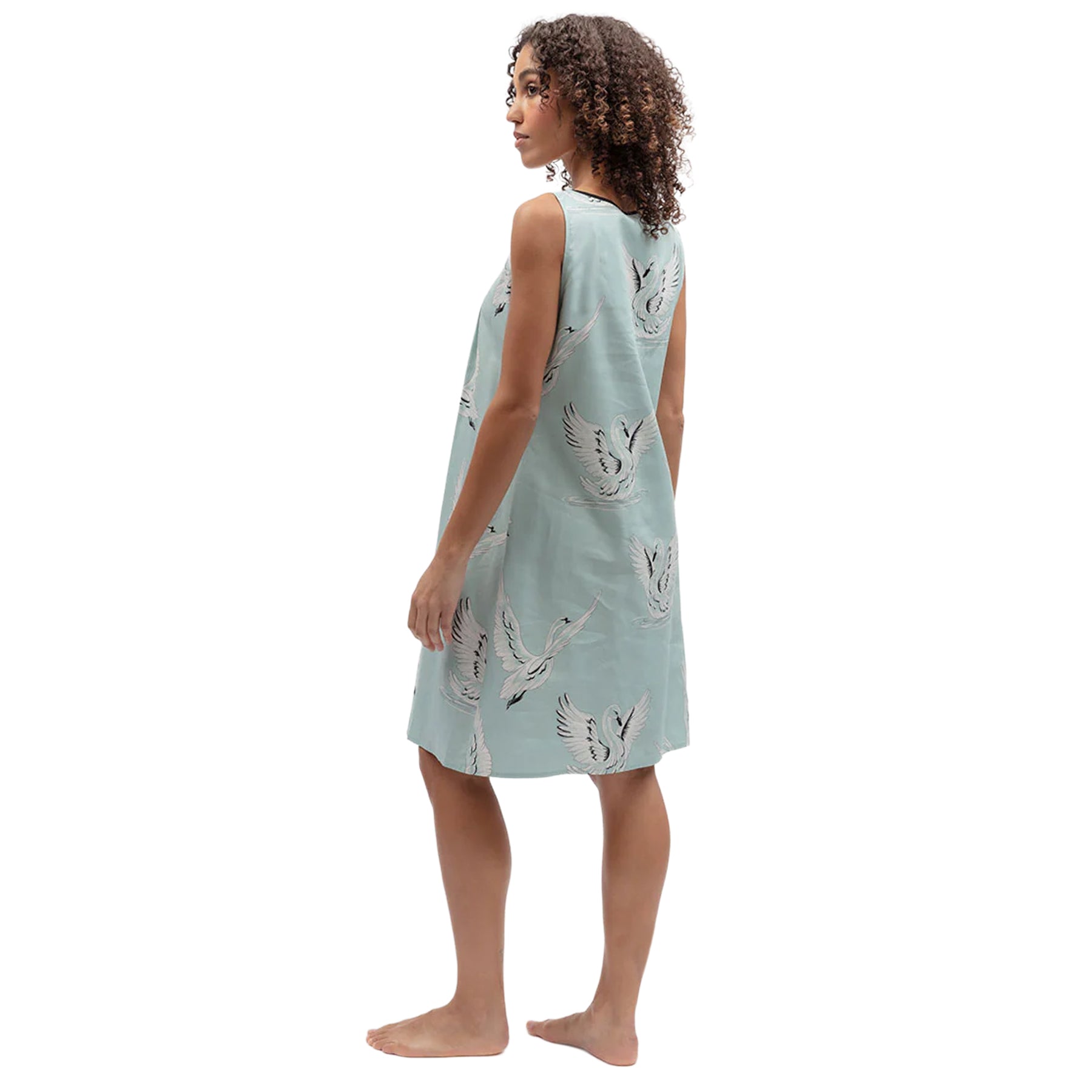 Side back view of mint blue cotton nightgown showcasing the flowing fit and all-over swan print design.