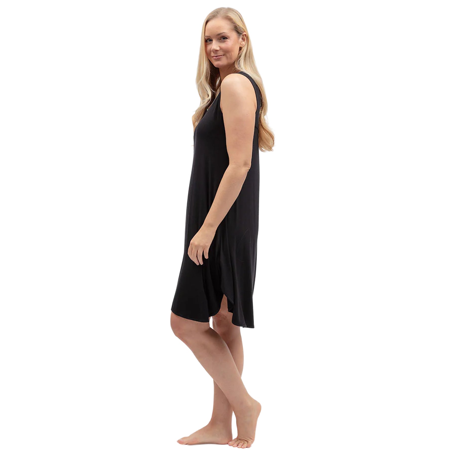 Side view of black jersey nightgown showcasing lightweight fabric, loose fit and curved flowing hemline.