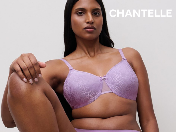 Chantelle purple full coverage lace bra and matching underwear set - model seated, front view.