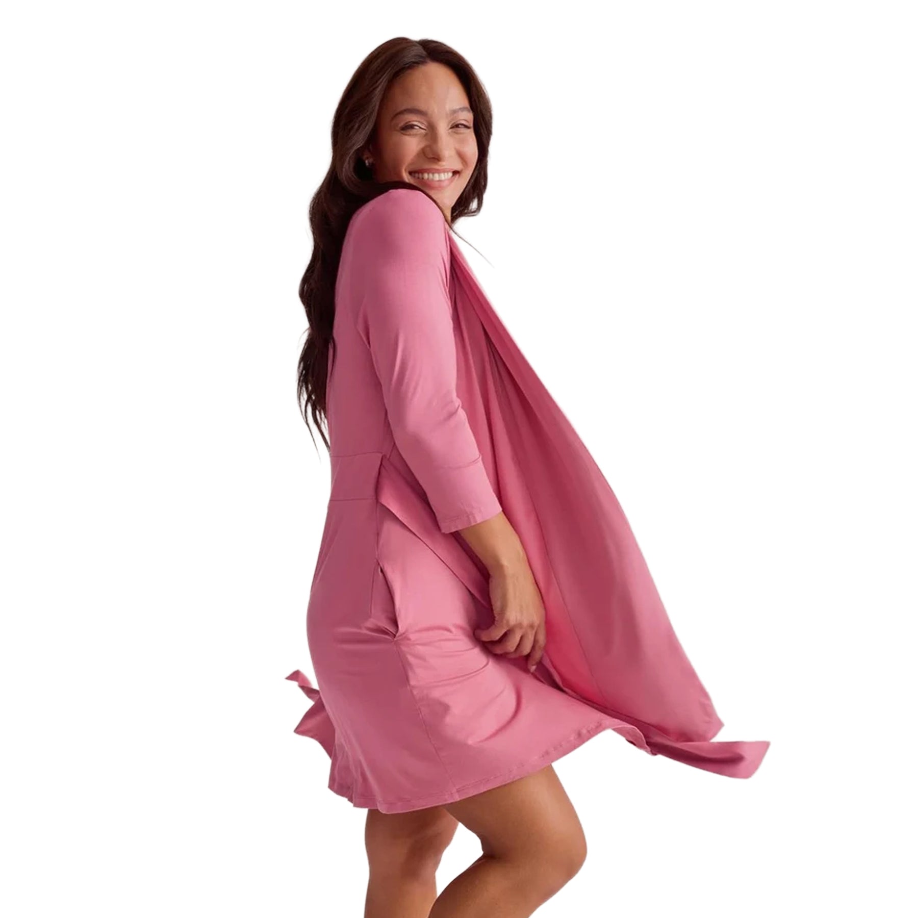 Side view of a woman wearing a flowing pink short robe with three-quarter sleeves and a waist tie.