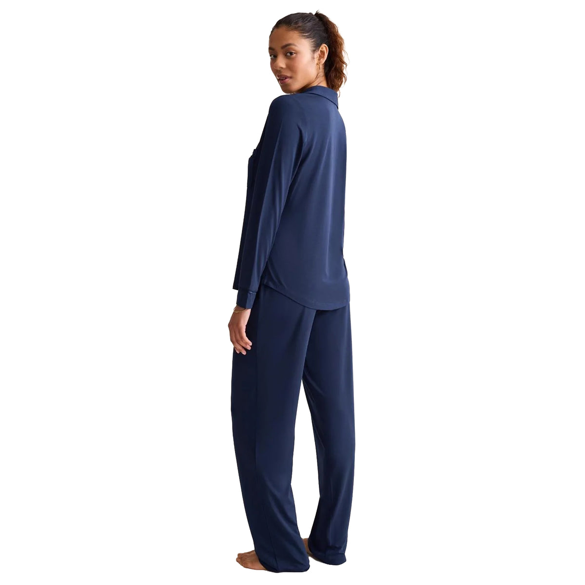 Rear view of Ink Navy pyjama set showcasing a long-sleeve collared top with a gently curved hem and matching loose-fitting full-length pants.
