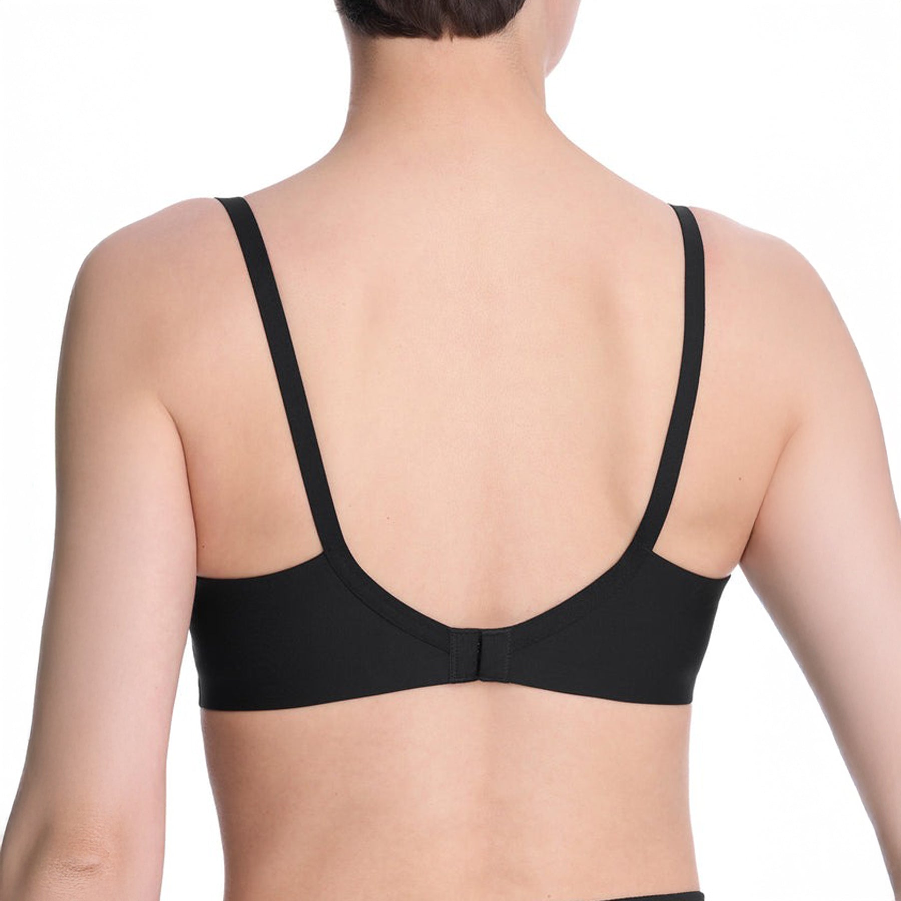 Back view of black spacer bra on model showing smooth band and adjustable straps.