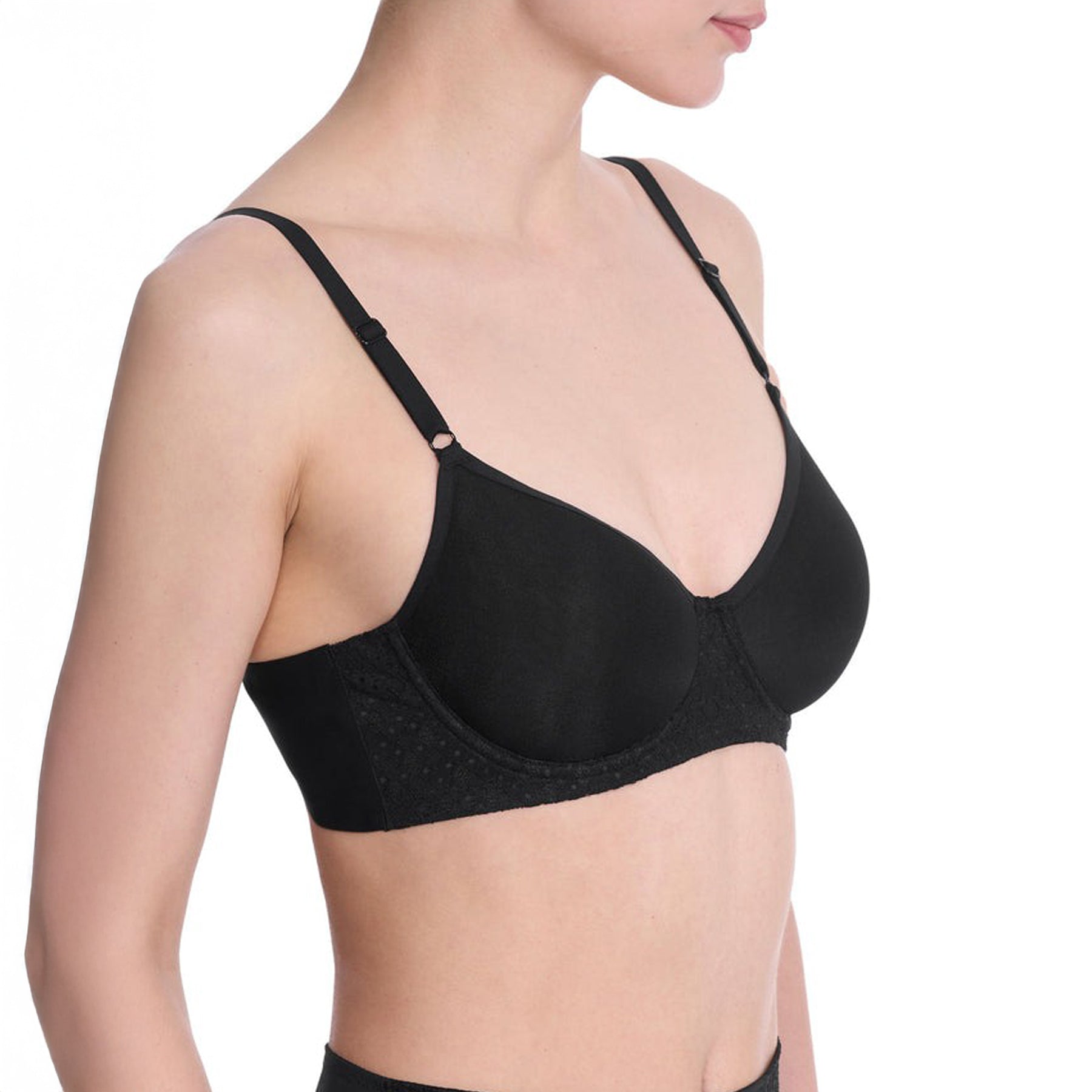 Side view of black spacer bra on model featuring seamless cups and lace side panel.