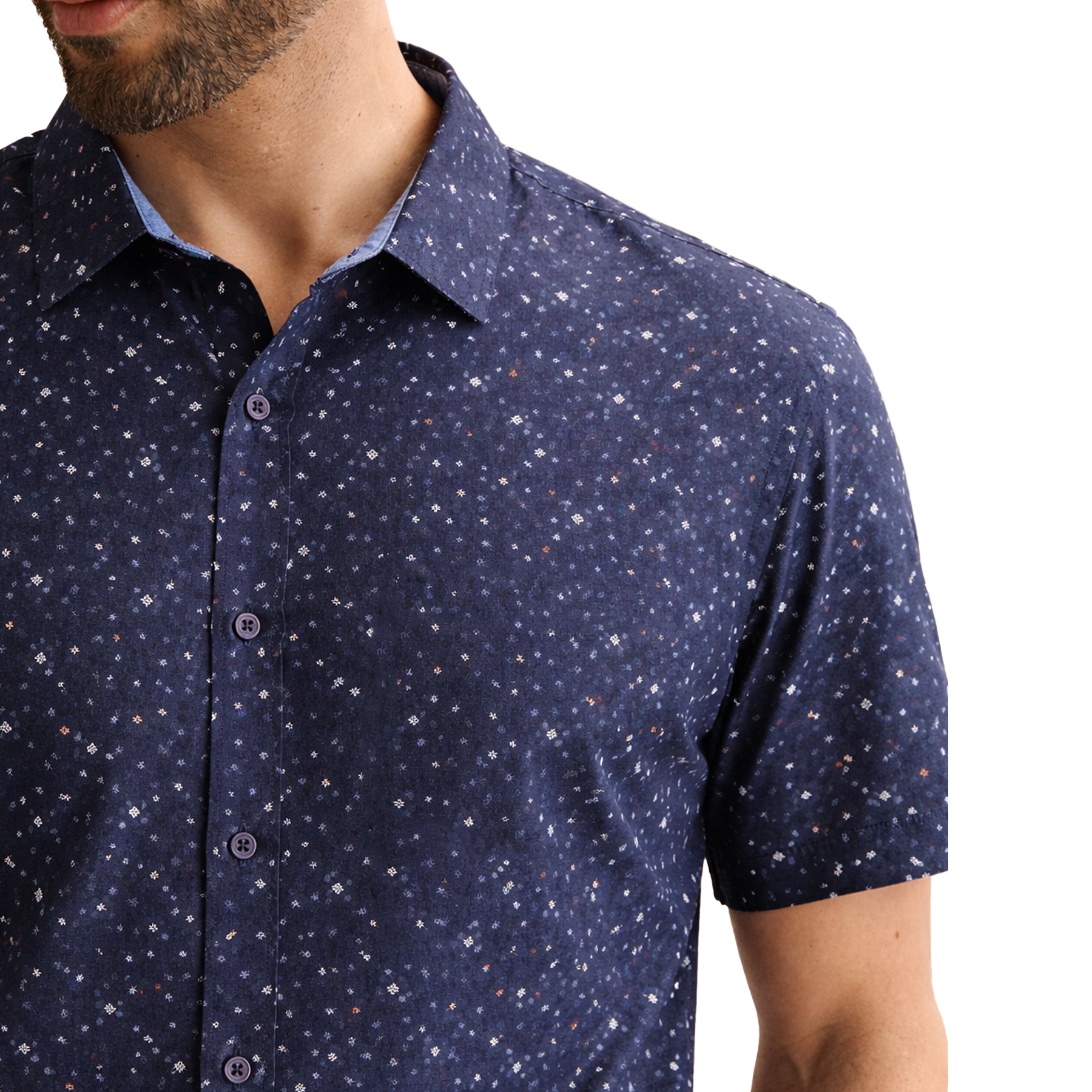 Close-up detail of navy short sleeve shirt showing micro-print pattern and buttons