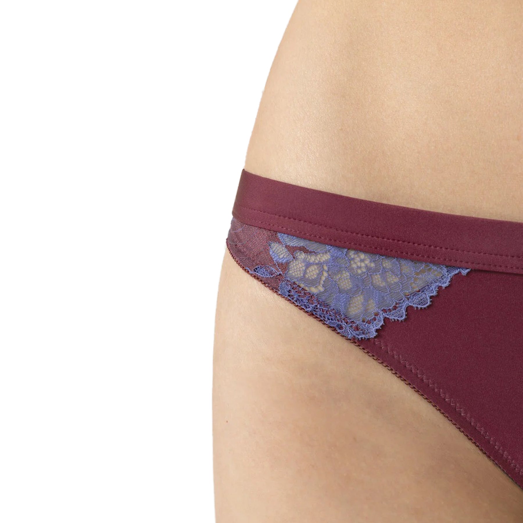Close-up of burgundy bikini briefs with sheer blue lace detailing at hip