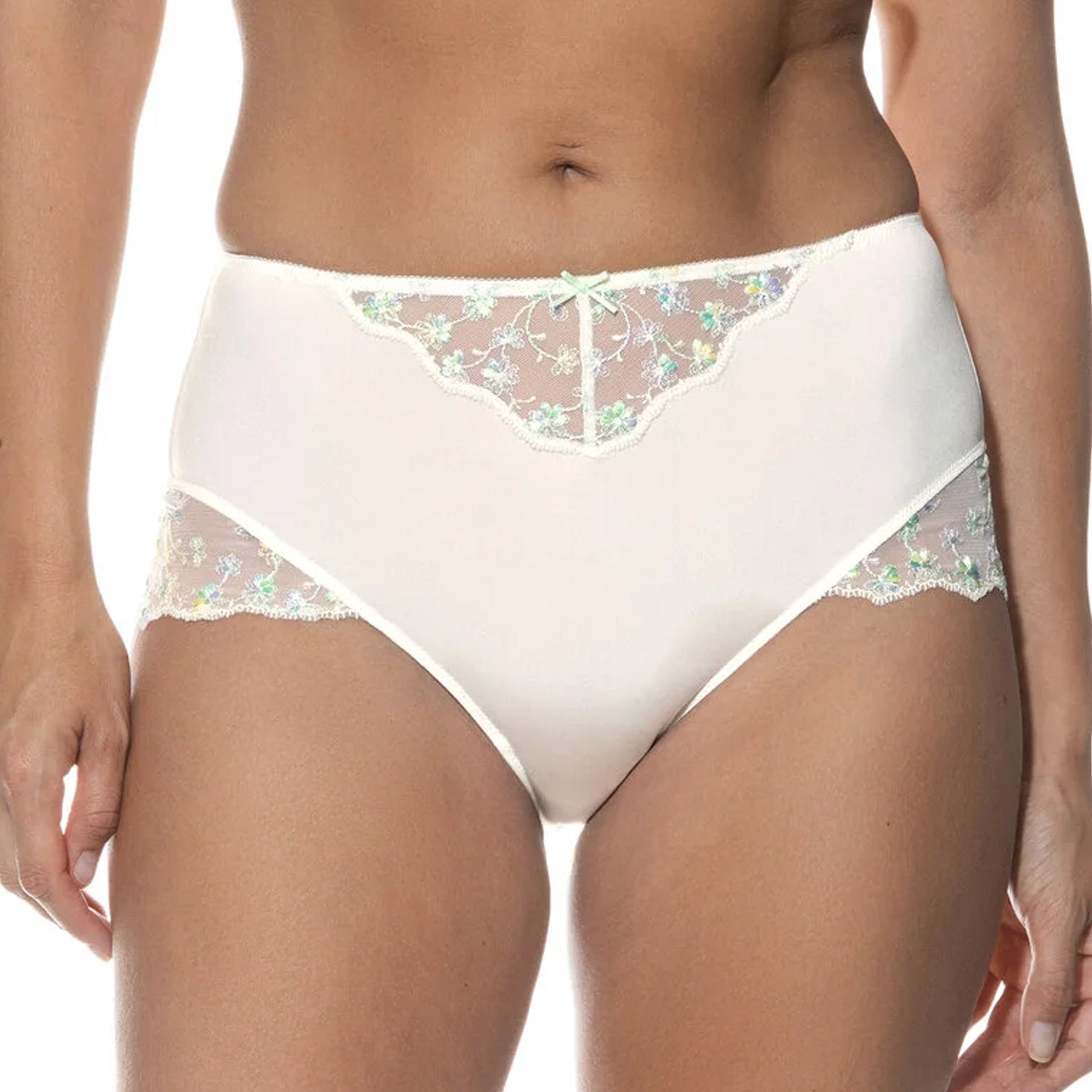 Front view of a woman wearing a high-waisted white brief with sheer floral embroidered panels and a small bow detail at the waist.
