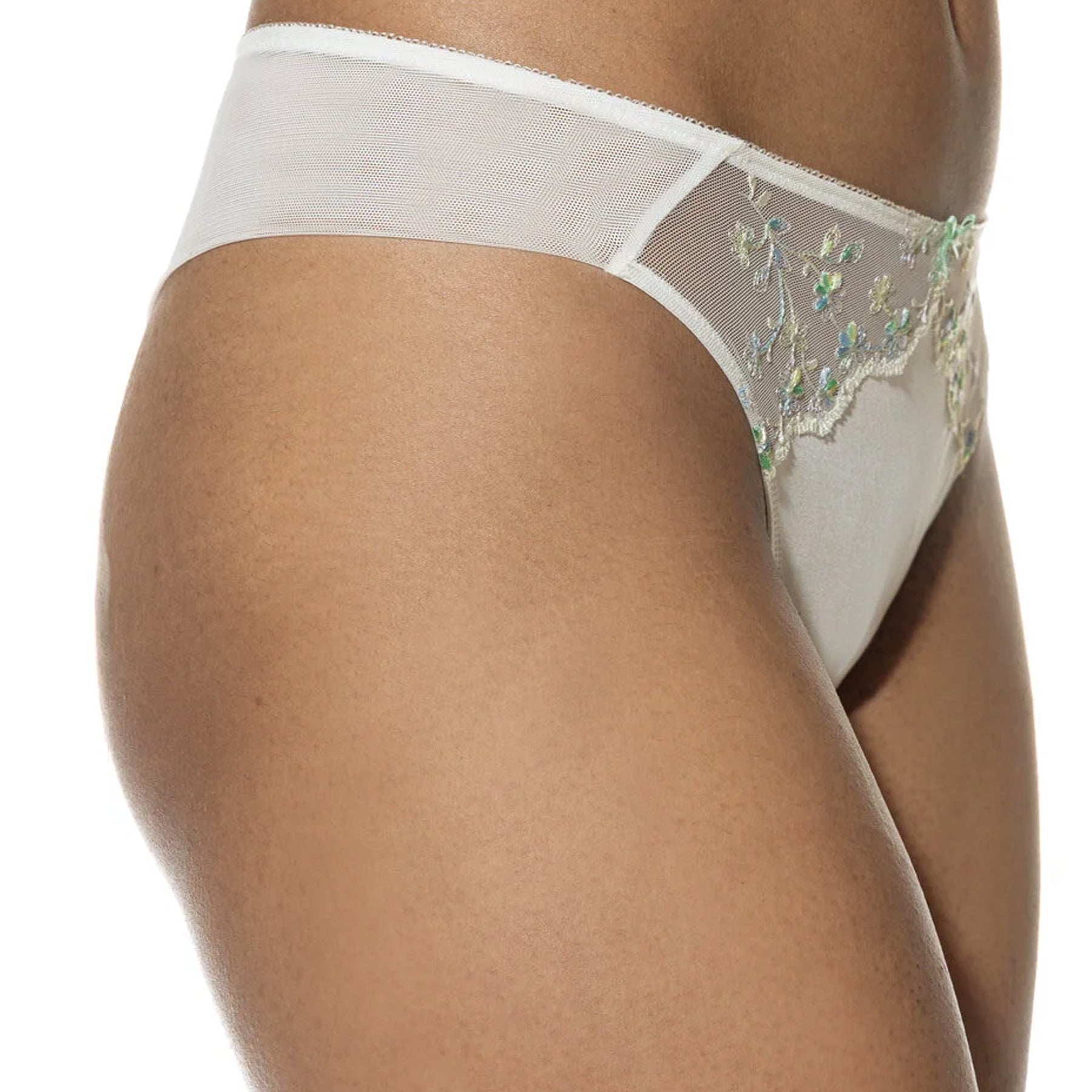 Side angle of the bikini brief highlighting the wide mesh side panel and delicate floral embroidery at the front.