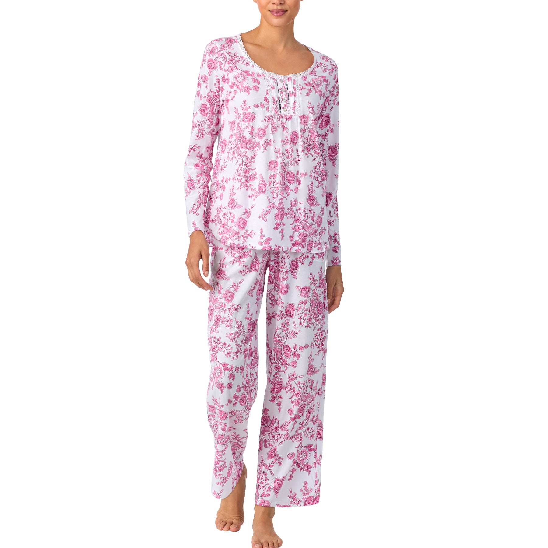 Woman wearing a pink floral pajama set on a white background