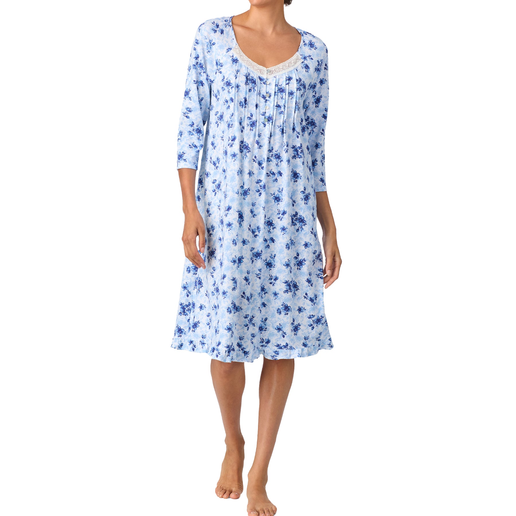 Woman wearing a blue floral nightgown on a white background
