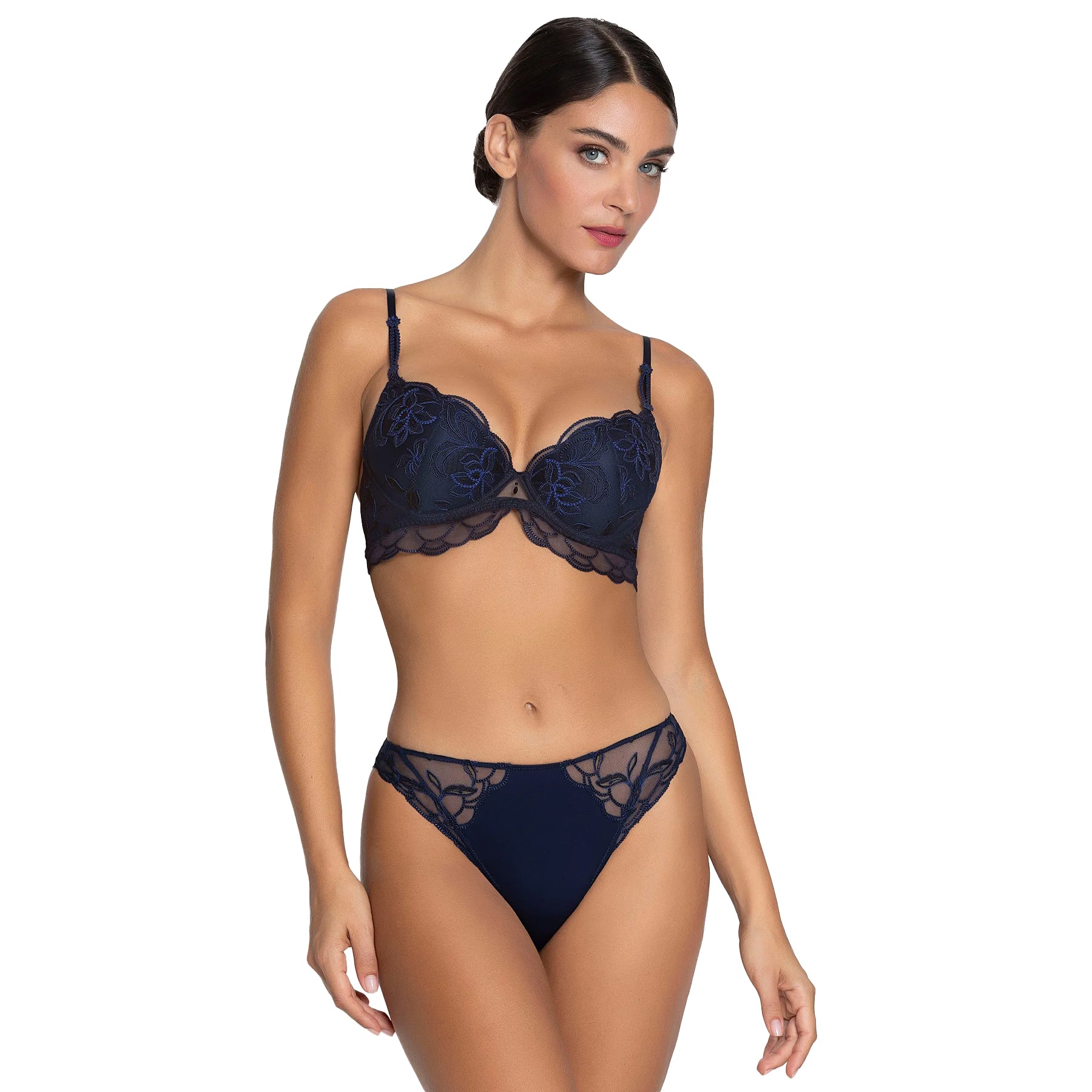 Woman wearing a navy blue lace lingerie set on a white background