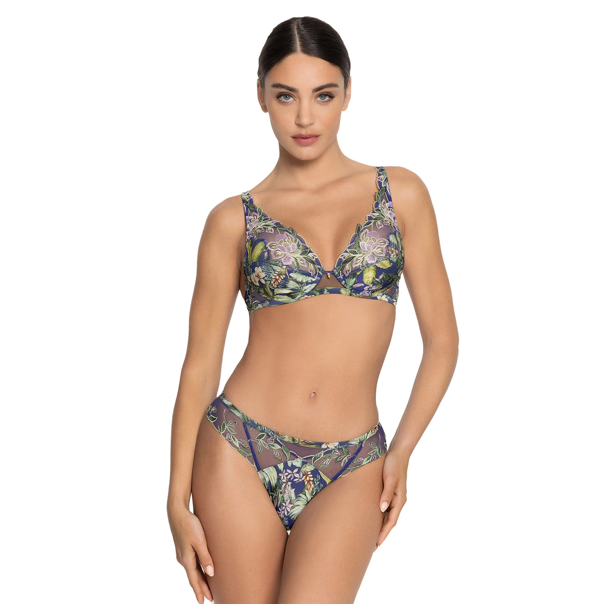 Model wearing Lise Charmel Bain de Nature thong with matching floral plunge bra in rich blue, green and lavender tones.