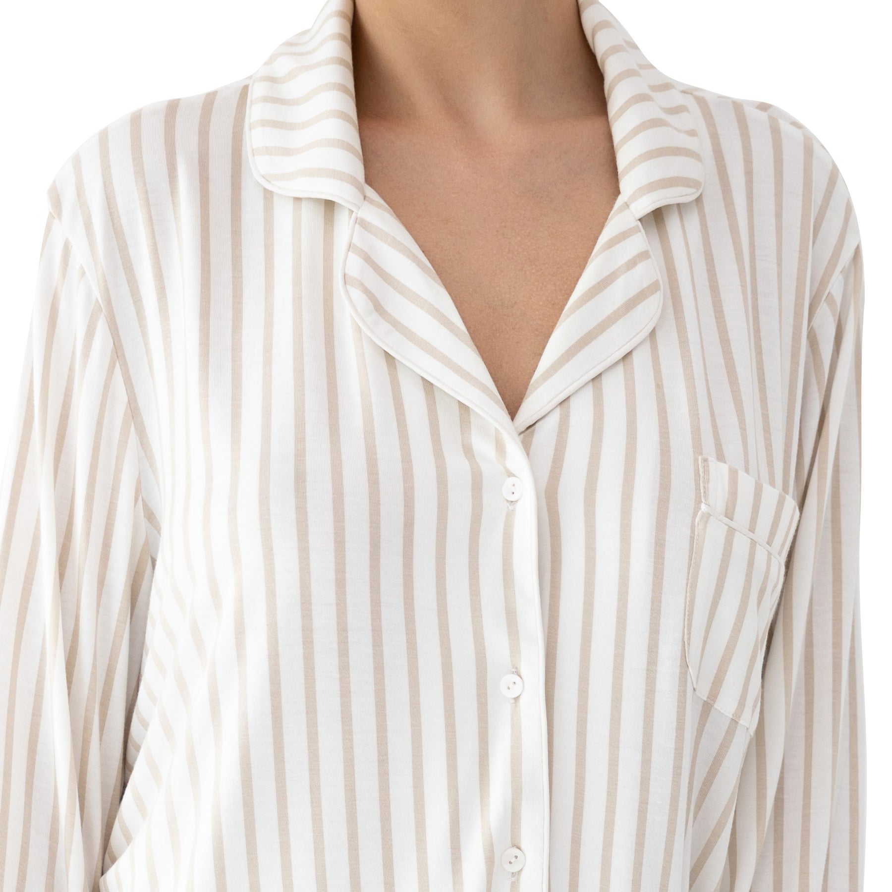 Detailed view of ivory beige striped pyjama top with collar, buttons and pocket, showcasing lightweight breathable fabric