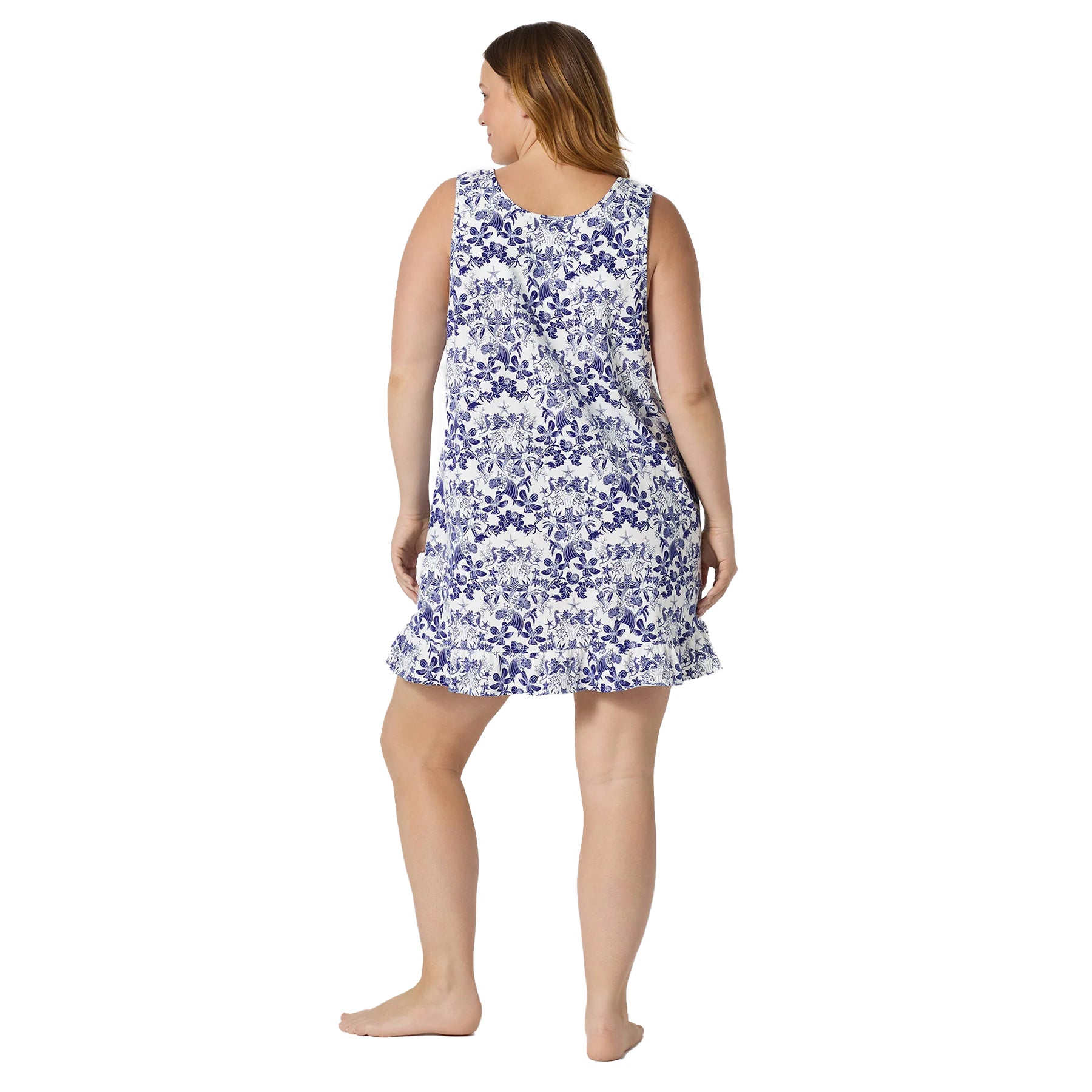 Back view of a sleeveless white and blue printed chemise with a relaxed fit and delicate ruffle trim at the hem.