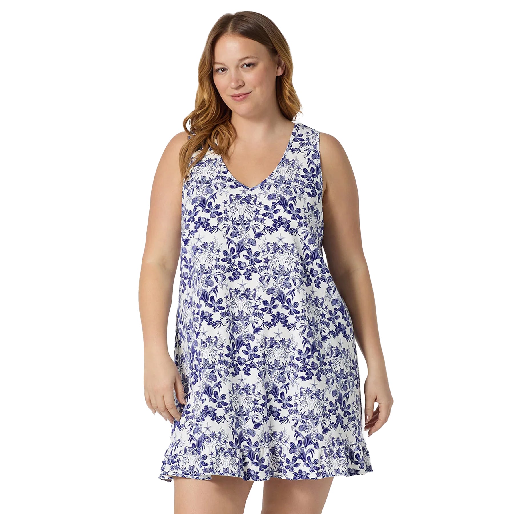 Plus size model wearing a white sleeveless chemise with blue ocean-inspired floral print and soft ruffle hem for lightweight comfort.