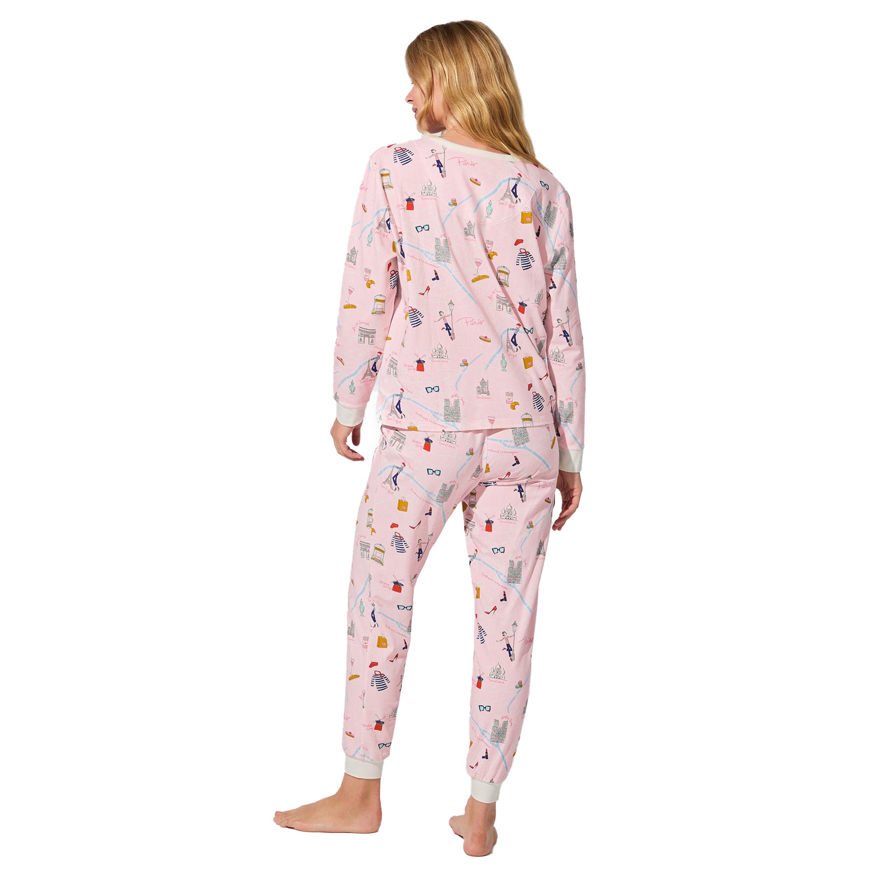Back view of straight-size model wearing blush pink Paris print long-sleeve pajama set with tapered pants.